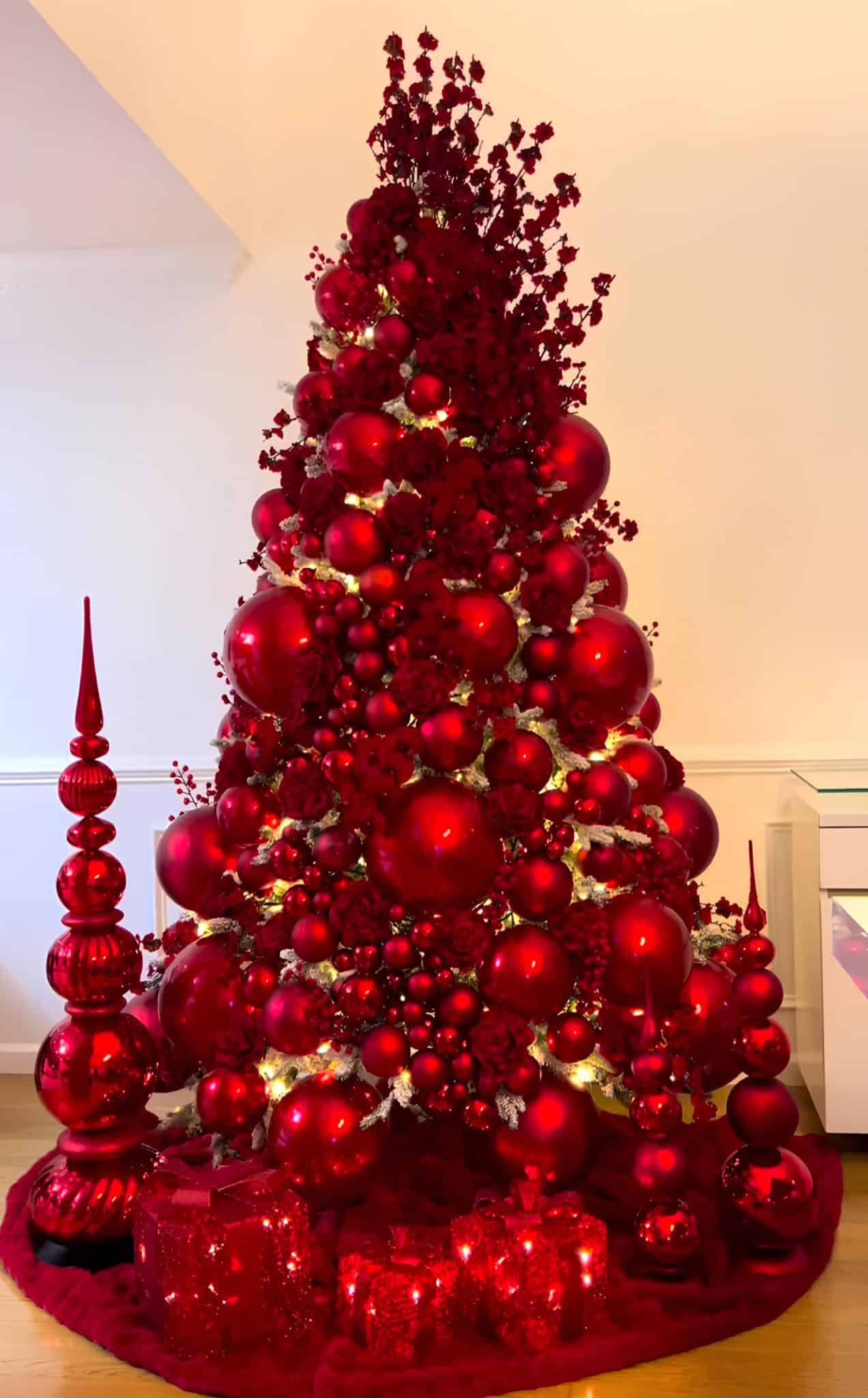 All red glamorous Christmas tree with monochromatic ornaments and glowing lights
