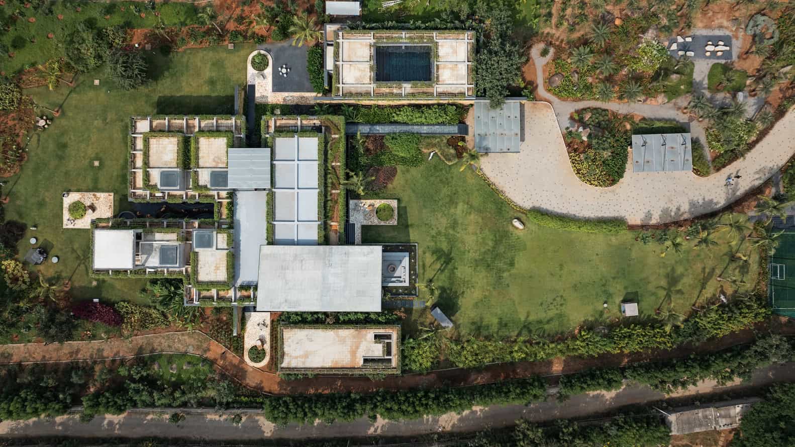 Antriya House Aerial Site Plan by 23 Degrees Design Shift Antriya House by 23 Degrees Design Shift — aerial view of site plan and green roofs, Hyderabad, India