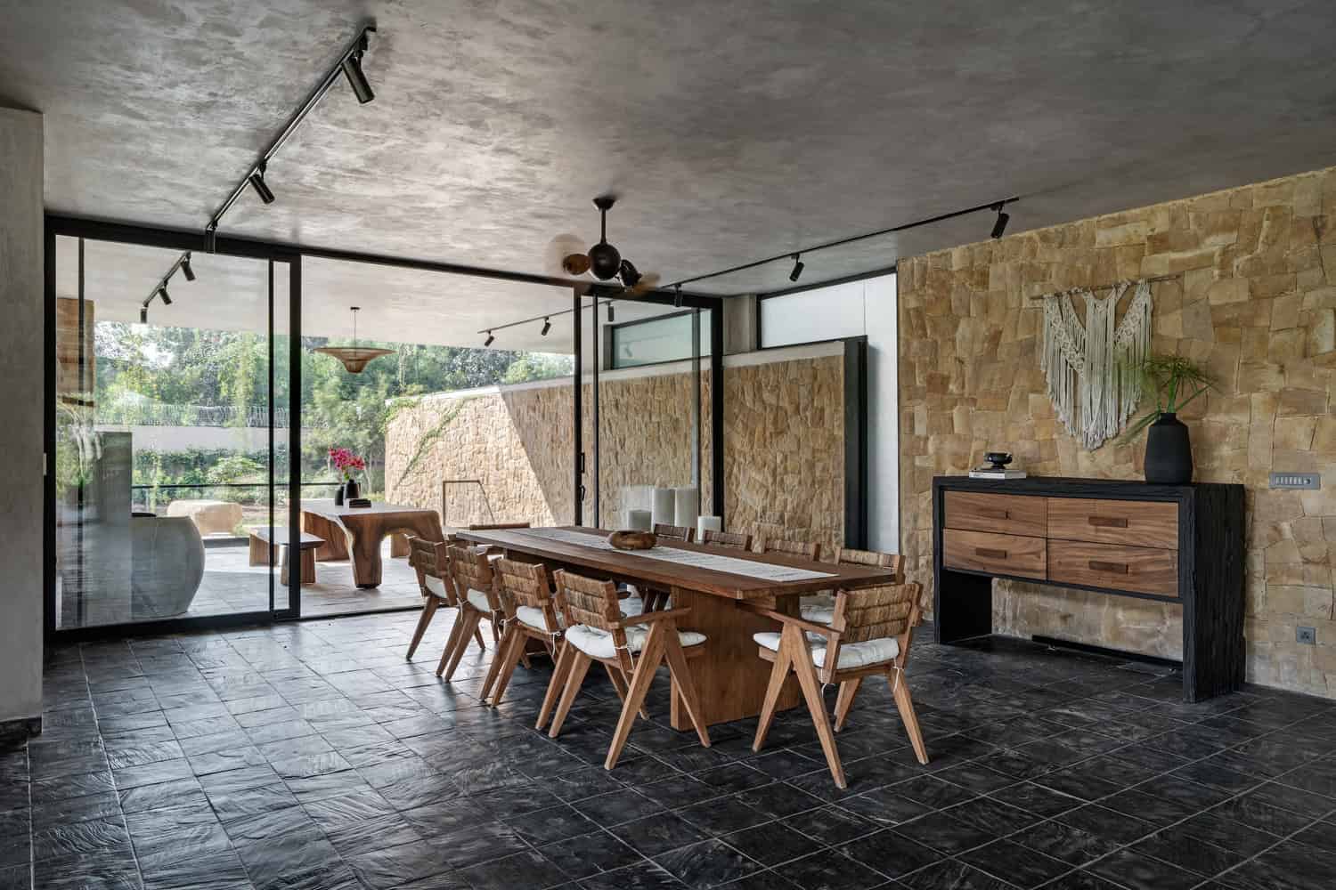 Antriya House Dining Room by 23 Degrees Design Shift Antriya House by 23 Degrees Design Shift — dining room with stone wall and timber furniture, Hyderabad, India