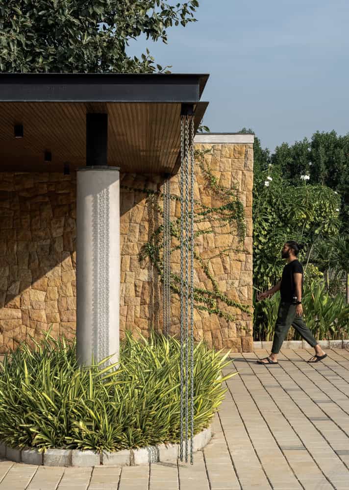 Antriya House Rain-Chain Entry Detail by 23 Degrees Design Shift Antriya House by 23 Degrees Design Shift — rain-chain detail at stone-clad entry, Hyderabad, India