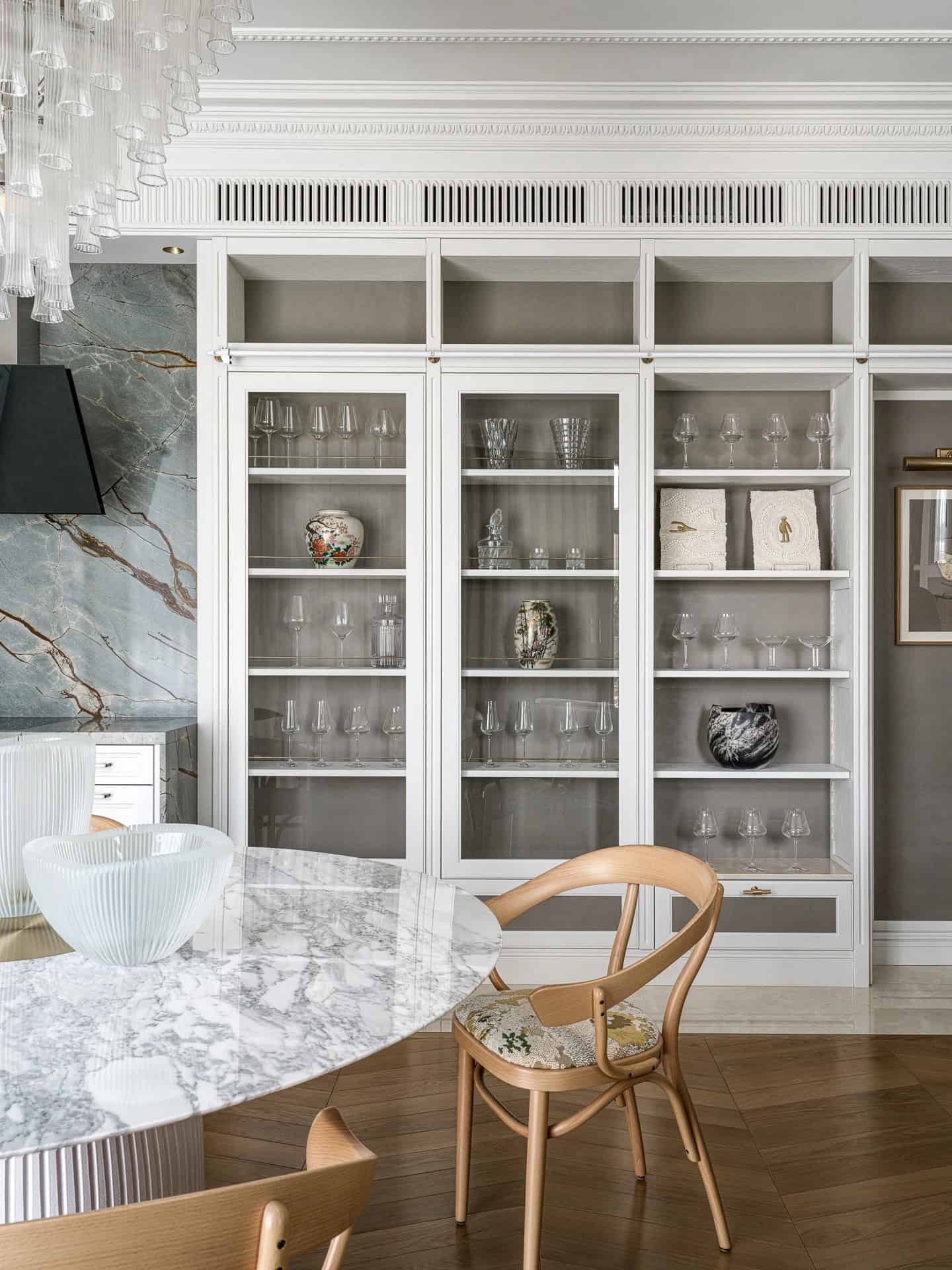 Apartment with a Parisian Mood for Collectors Display Cabinet Detail by AABA Architects Built-in glass display cabinet with crystalware in the Apartment with a Parisian Mood for Collectors by AABA Architects, Moscow