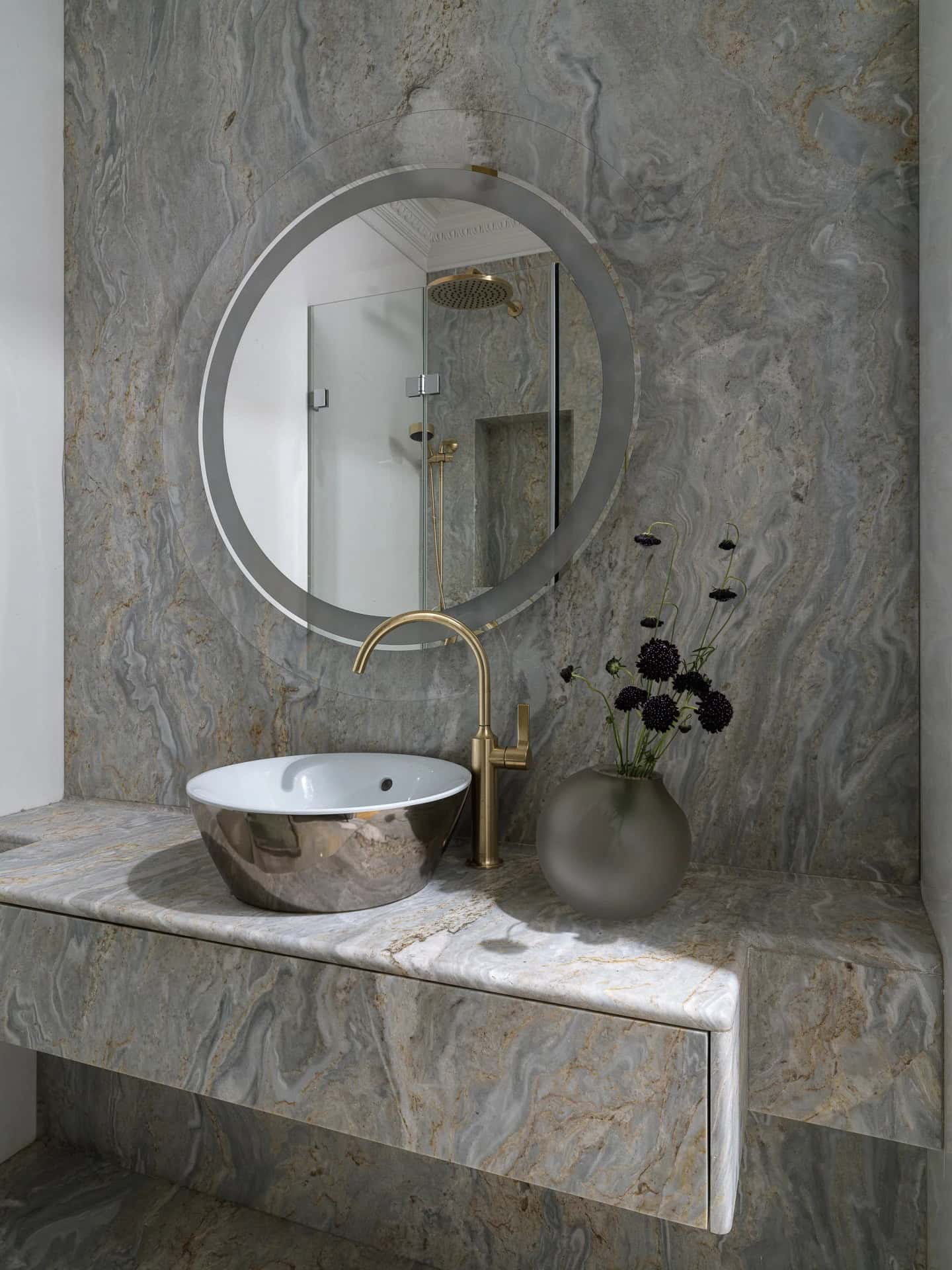 Apartment with a Parisian Mood for Collectors Powder Room Vanity by AABA Architects Powder room with round mirror and stone vanity — AABA Architects, Moscow