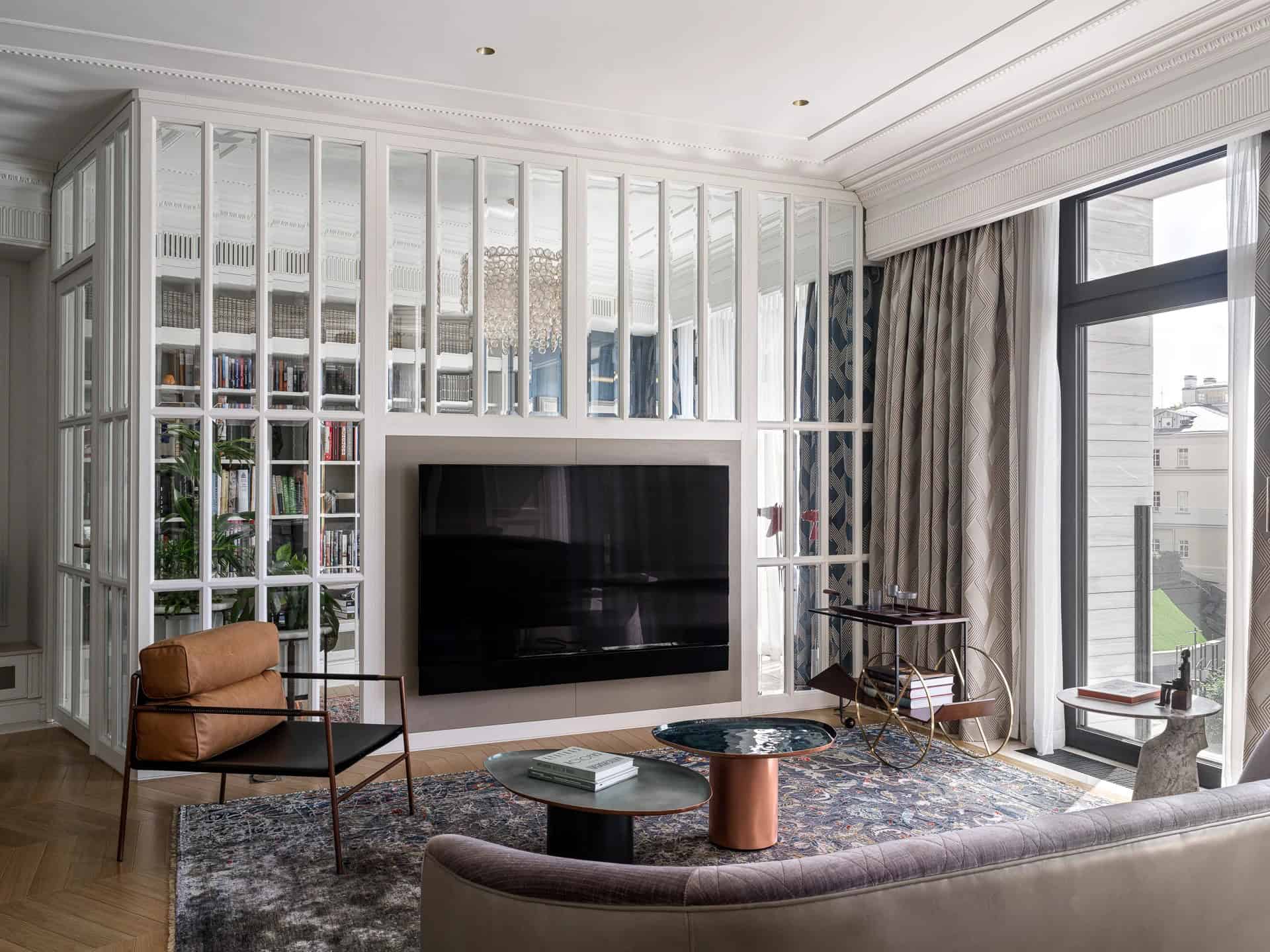 Apartment with a Parisian Mood for Collectors TV Wall with Library by AABA Architects TV wall with surrounding glazed library in the Apartment with a Parisian Mood for Collectors by AABA Architects, Moscow