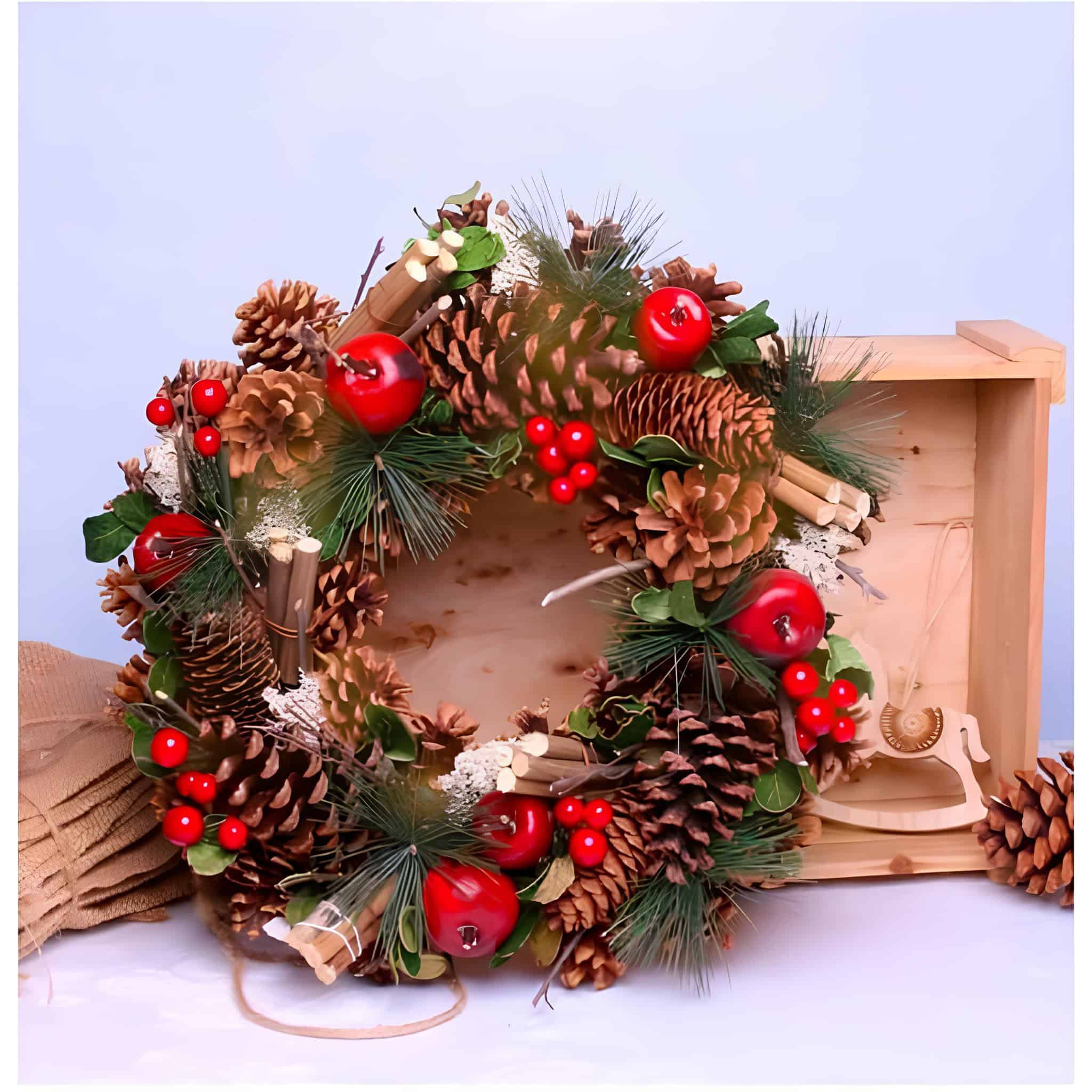 Rustic pinecone wreath with red apples, cinnamon sticks, and pine sprigs