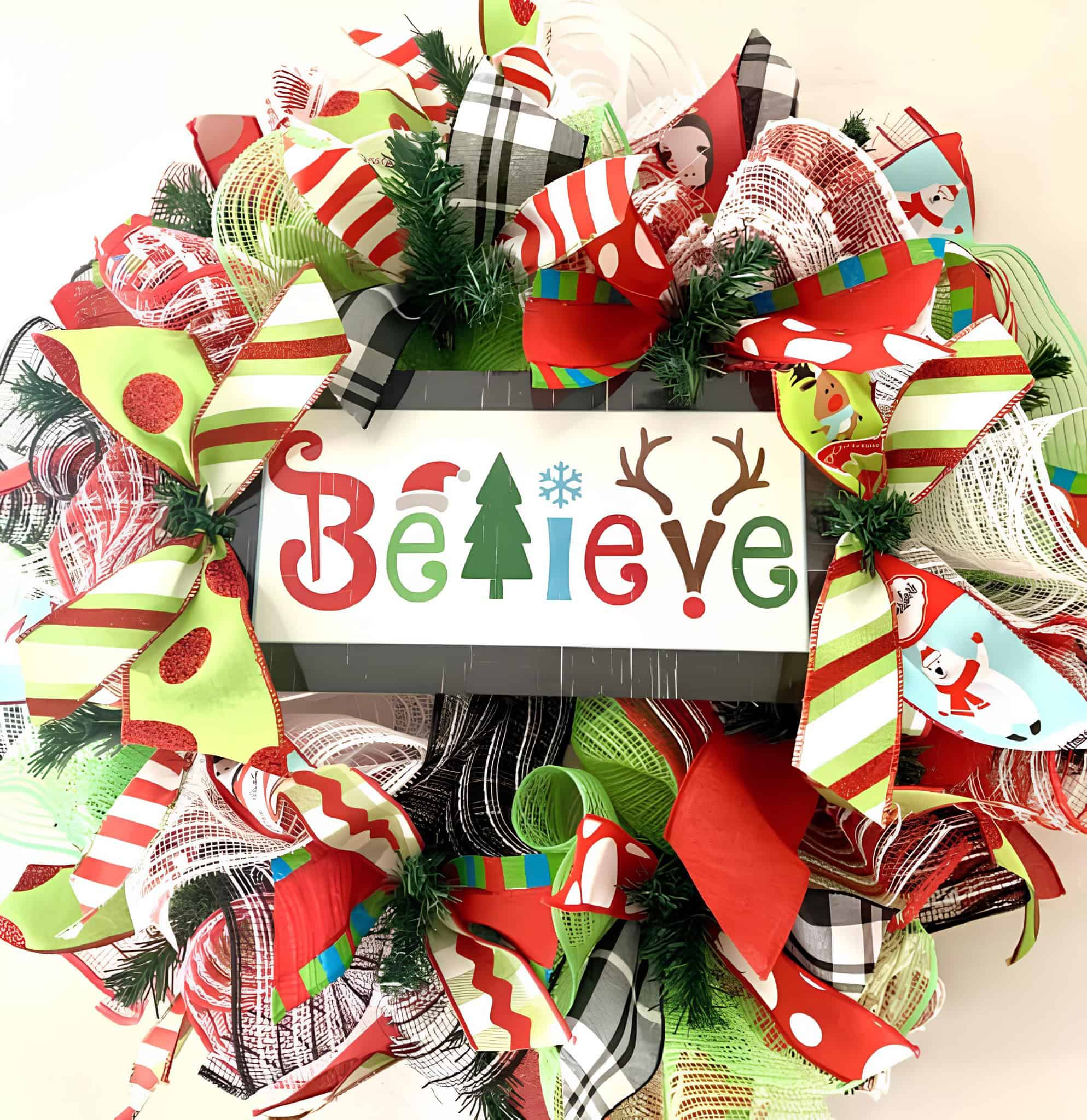 Bright ribbon wreath with Believe sign, candy stripes and green accents