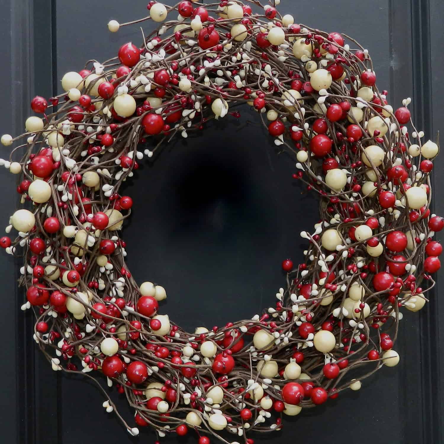 Classic twig wreath packed with red and cream berries
