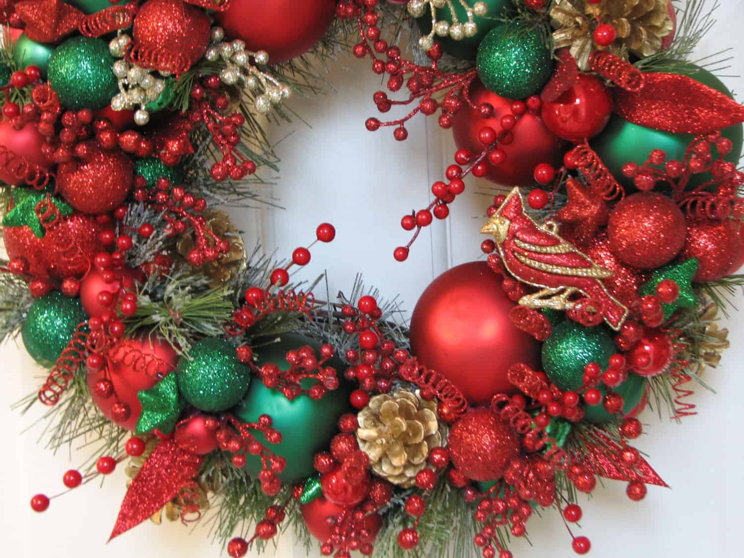 Lux red and green ornament wreath accented with red berries and gold details