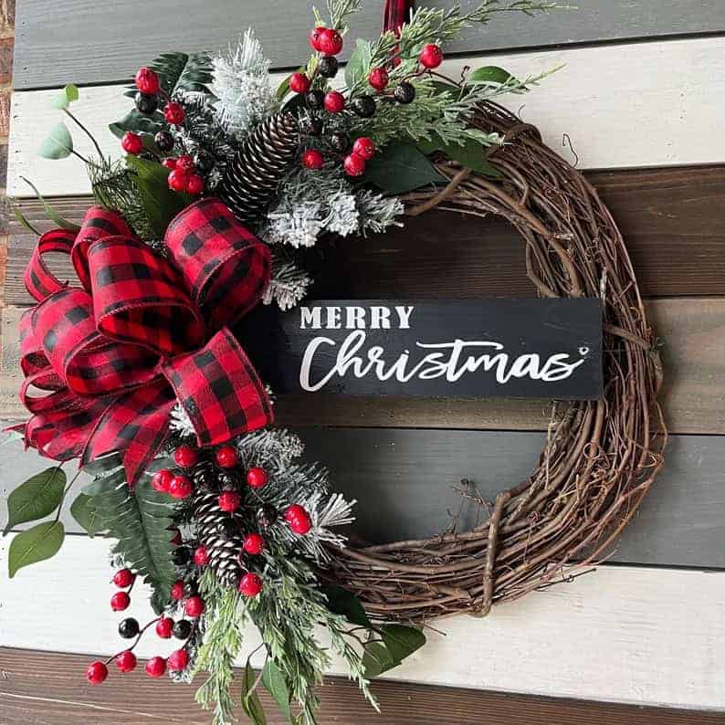 Rustic grapevine Christmas wreath with plaid ribbon and red berries