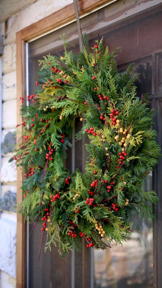 Traditional Christmas wreath with red berries and fresh greenery