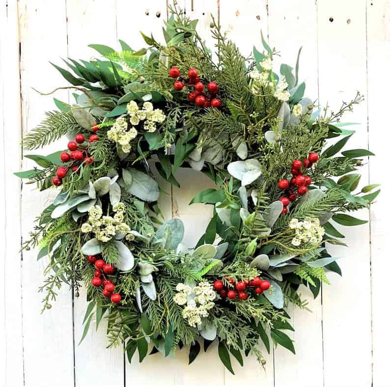 Natural eucalyptus Christmas wreath with red berries and white flowers