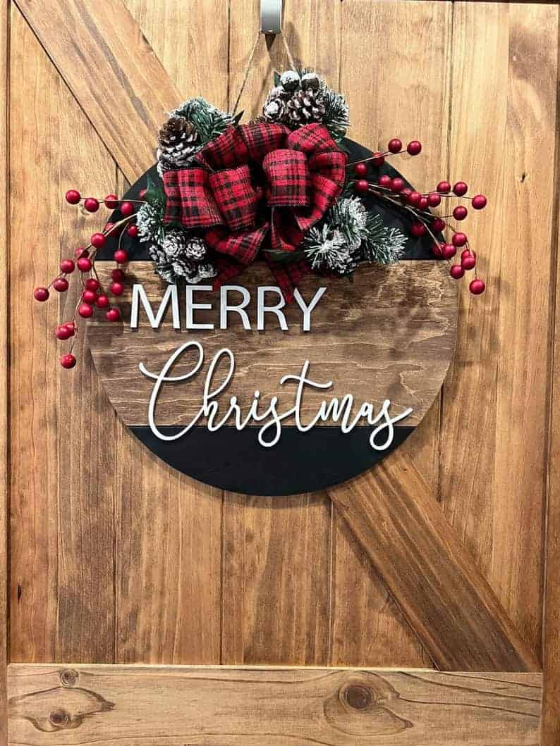 Wooden round Christmas wreath with plaid bow and berry accents