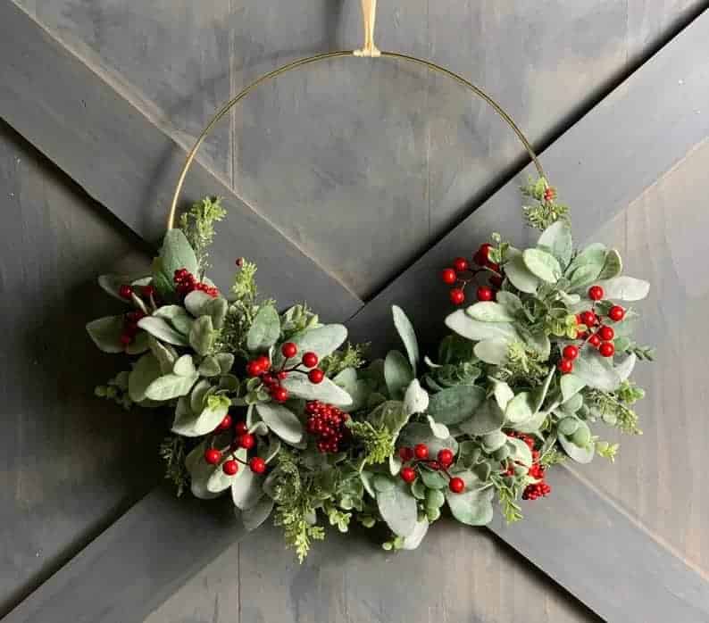 Minimal Christmas wreath with eucalyptus leaves and red berries
