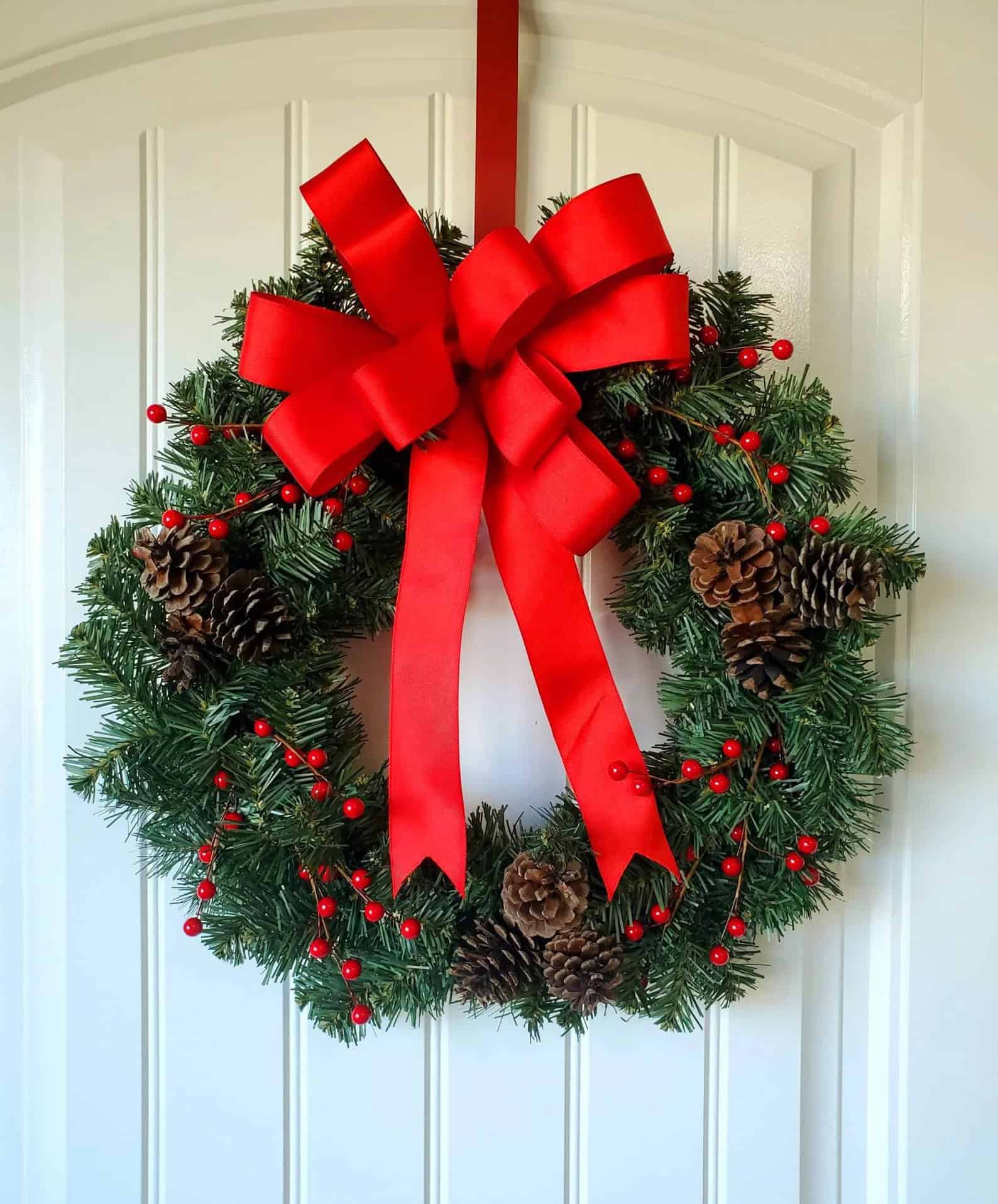 Classic pinecone Christmas wreath with red berries and evergreen foliage