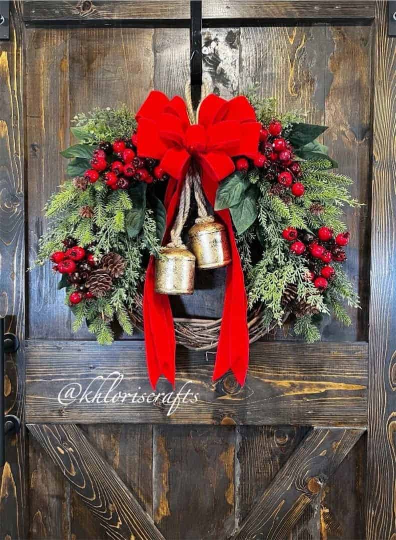 Festive Christmas wreath with red bow, golden bells, and pine accents