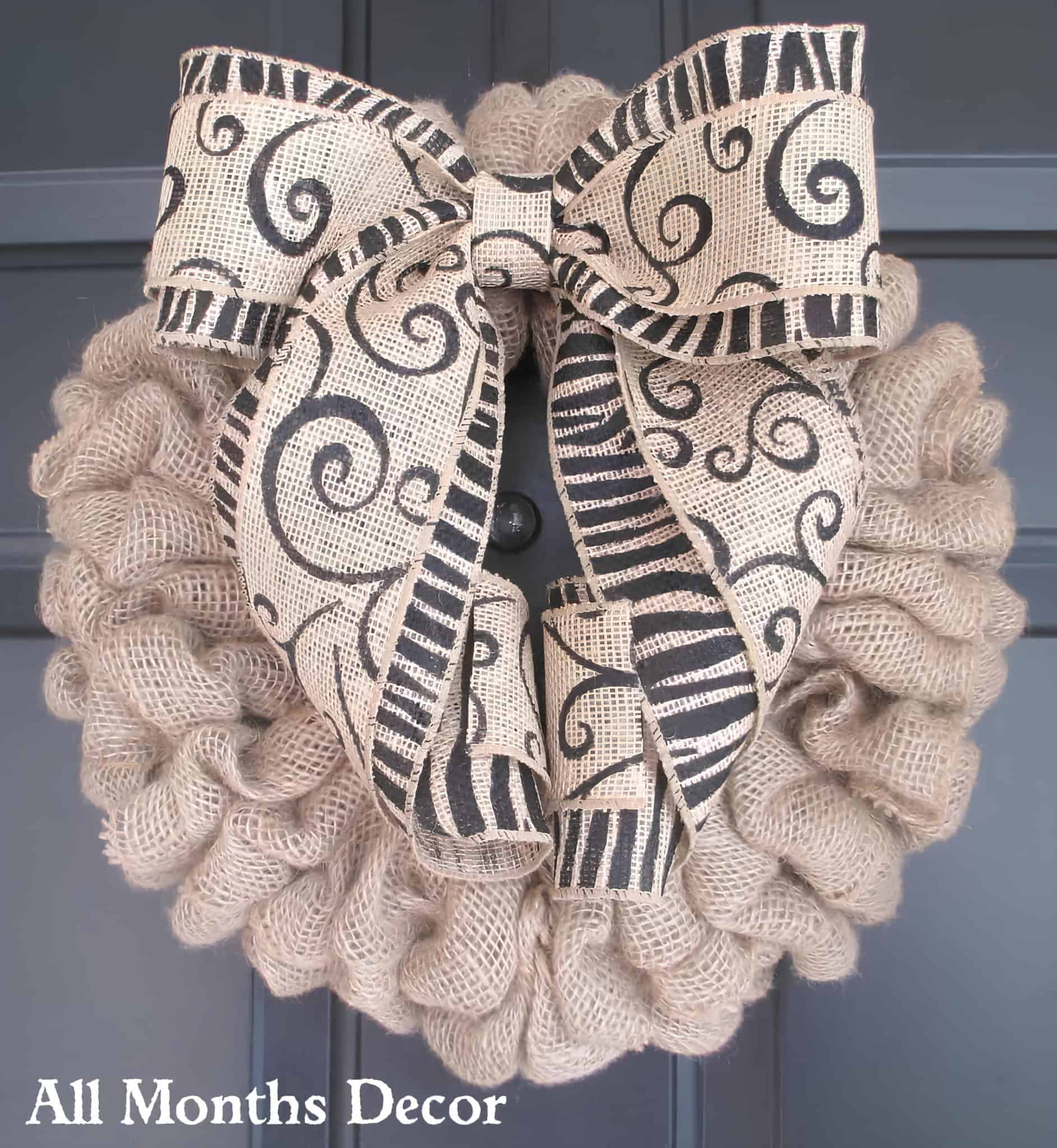 Natural burlap Christmas wreath with large black swirl bow