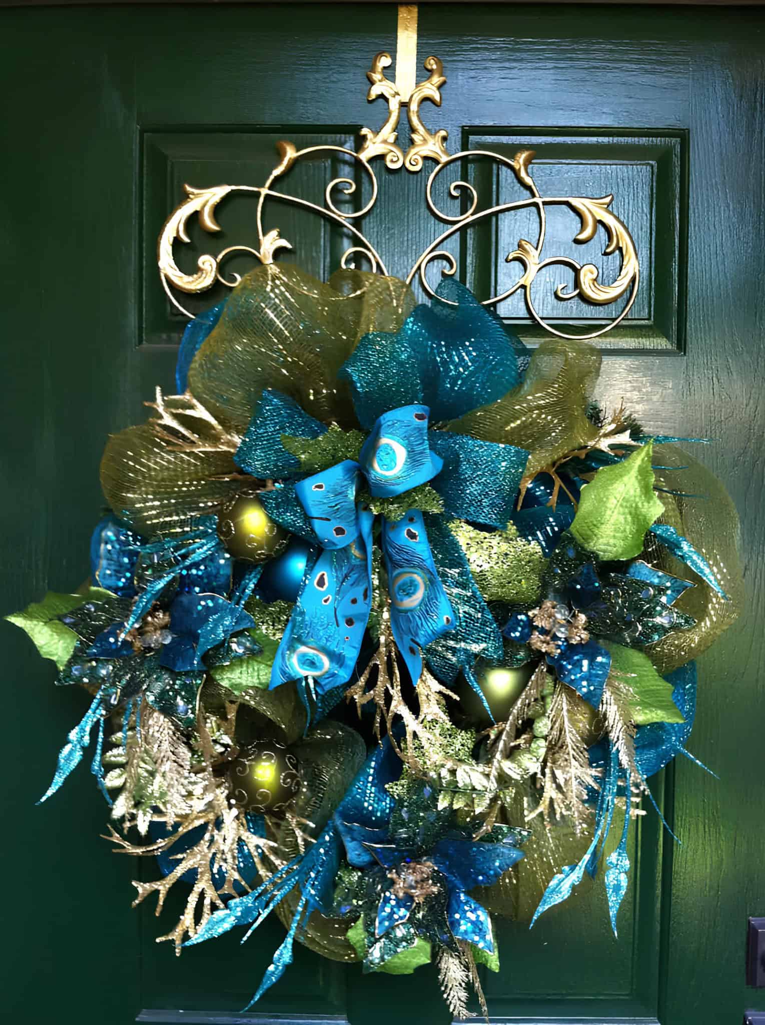 Peacock-inspired Christmas wreath with blue, green, and gold ribbons