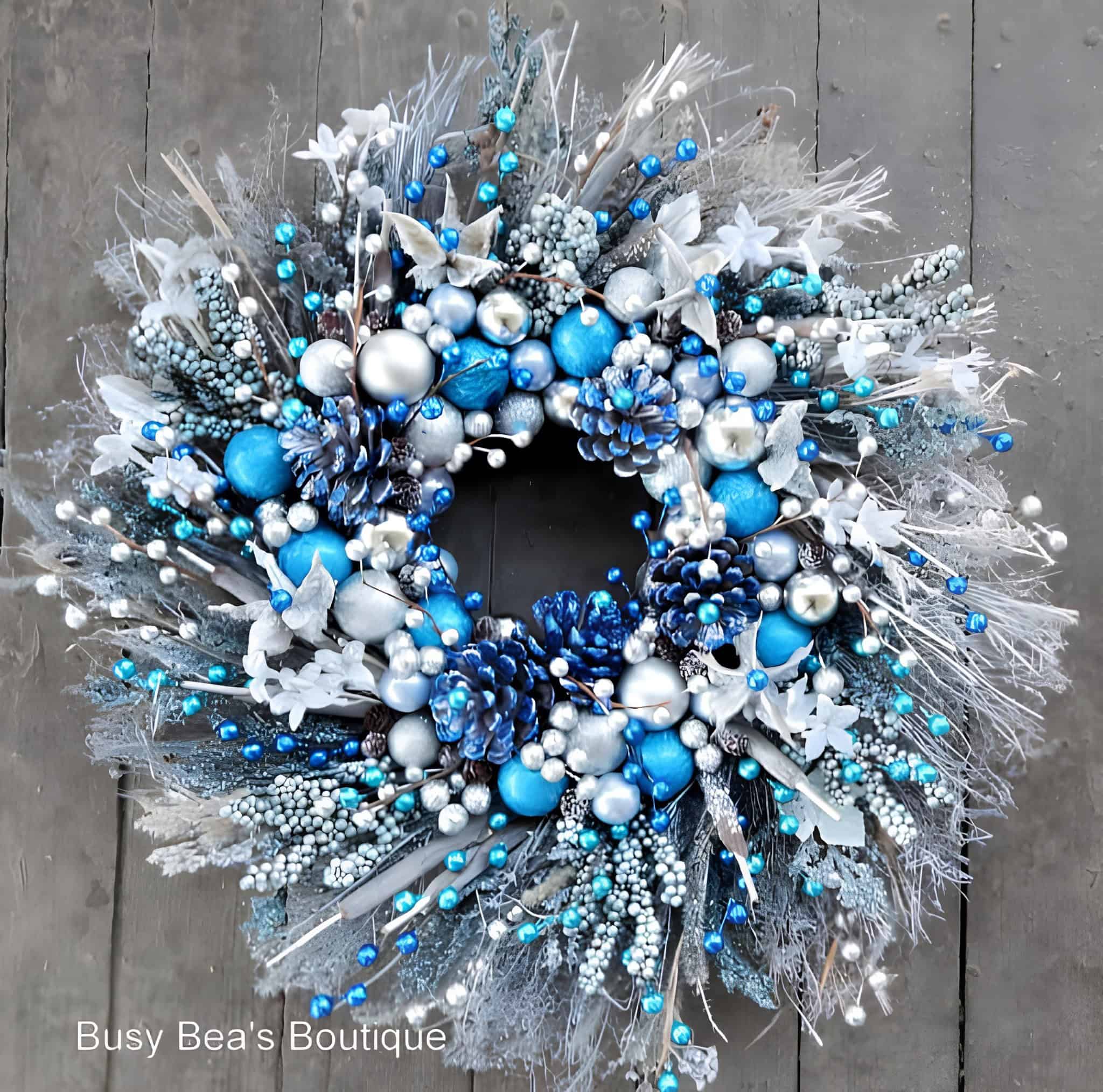 Blue and silver Christmas wreath with pinecones and frosted accents
