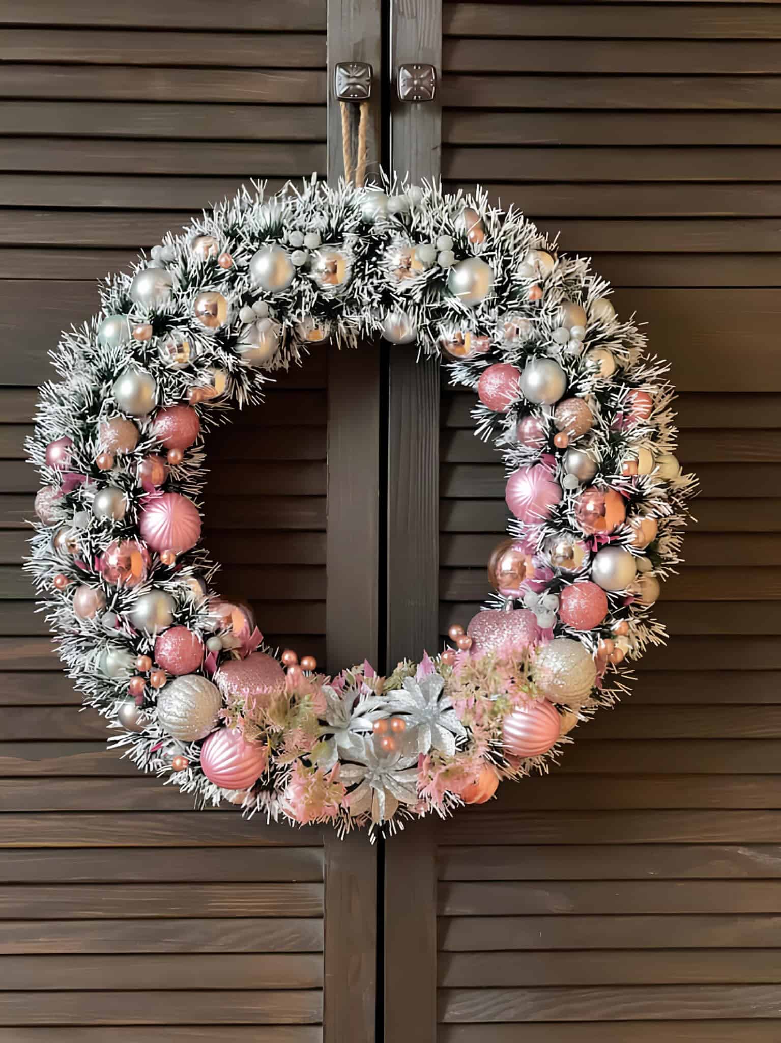 Blush and silver lantern wreath with frosted greenery and baubles