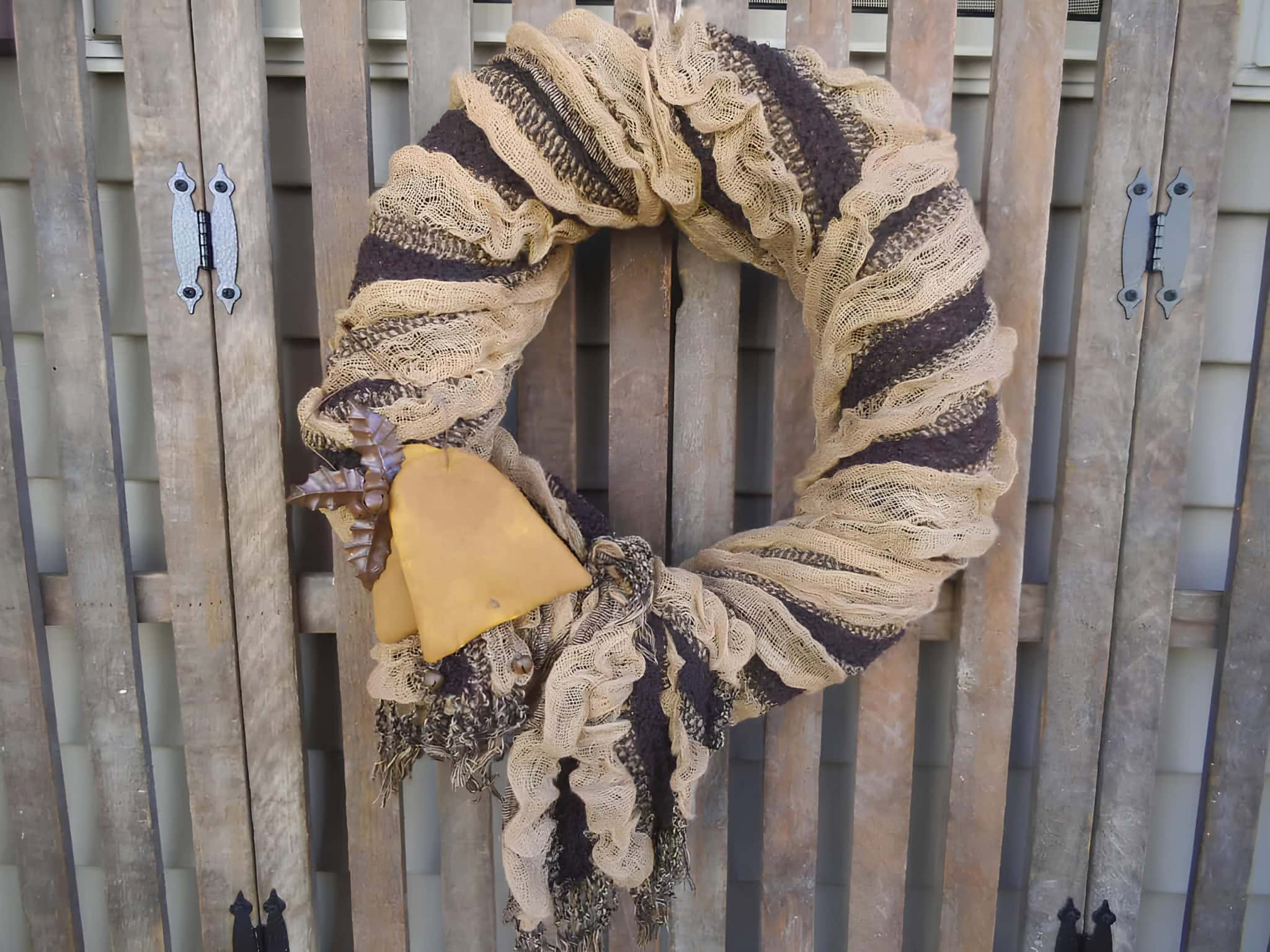 Brown and beige burlap Christmas wreath with primitive bell ornament