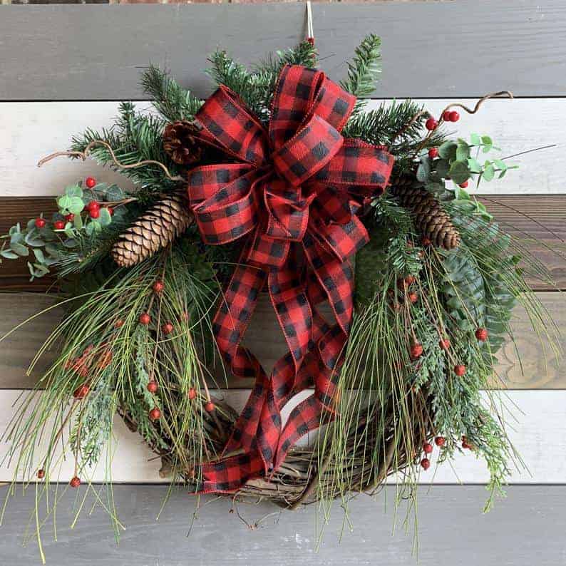 Buffalo check ribbon wreath with red berries and pinecones
