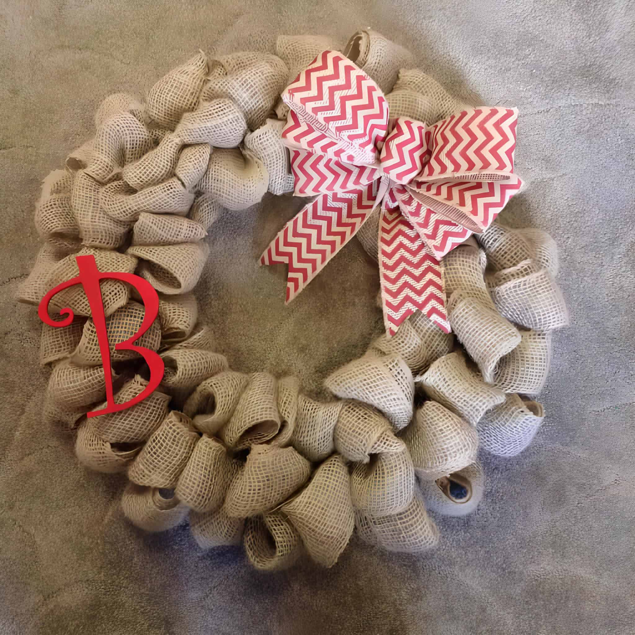 Rustic burlap Christmas wreath with red chevron bow and monogram
