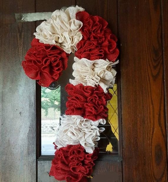 Red and white fabric wreath door decoration, handcrafted ruffle rags, perfect for rustic or farmhouse Christmas decor. Unique textiles art piece for holiday home decor, decorative craft ideas.