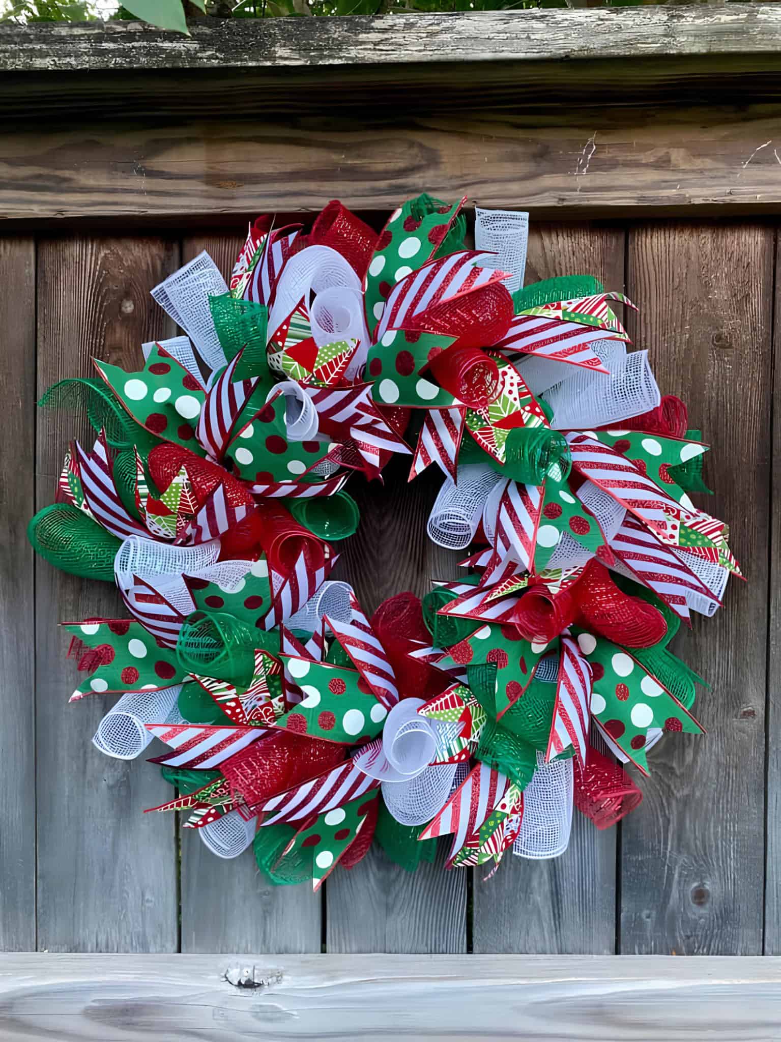 Deco mesh ribbon wreath in red, white and green with candy stripes and polka dots