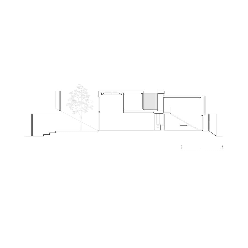 Casa T / SSAA / Thailand A modern architectural section drawing showing interior layout and structural design of a contemporary building with natural lighting elements.