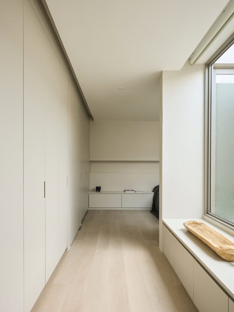 Casa T Bedroom Corridor by SSAA Casa T by SSAA, soft-toned bedroom corridor with storage in Bangkok, Thailand