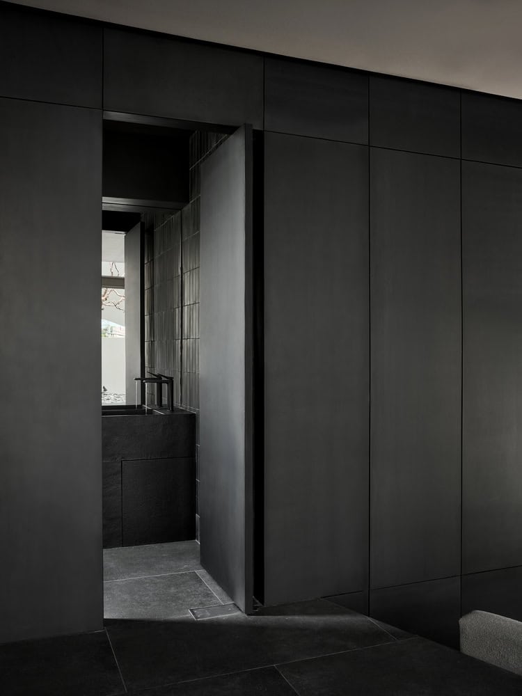 Casa T Corridor Bathroom Door by SSAA Casa T by SSAA, corridor leading to minimalist black bathroom in Bangkok, Thailand