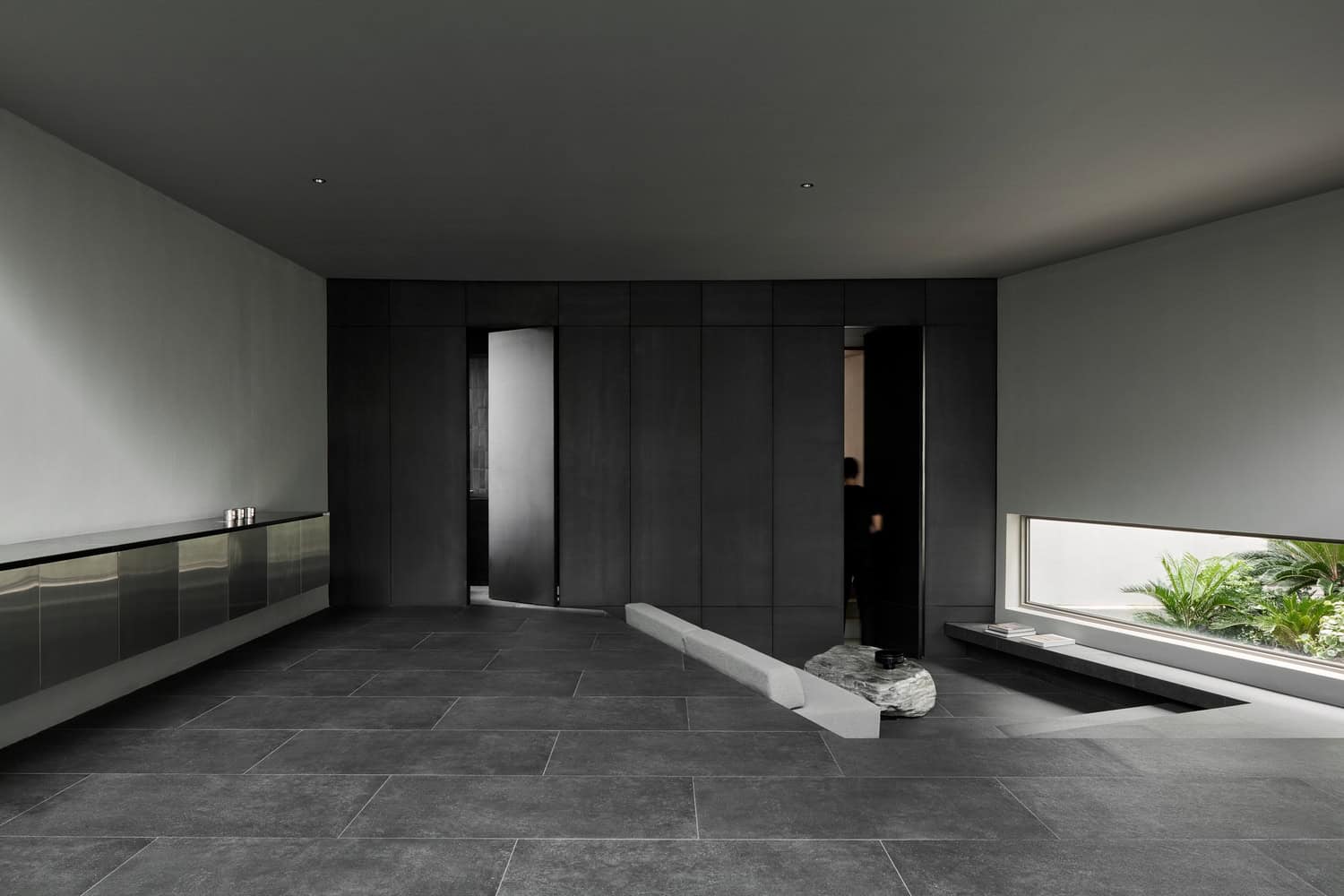Casa T Dark Interior Panels by SSAA Casa T by SSAA, black wall panels and sculptural stone table in Bangkok, Thailand
