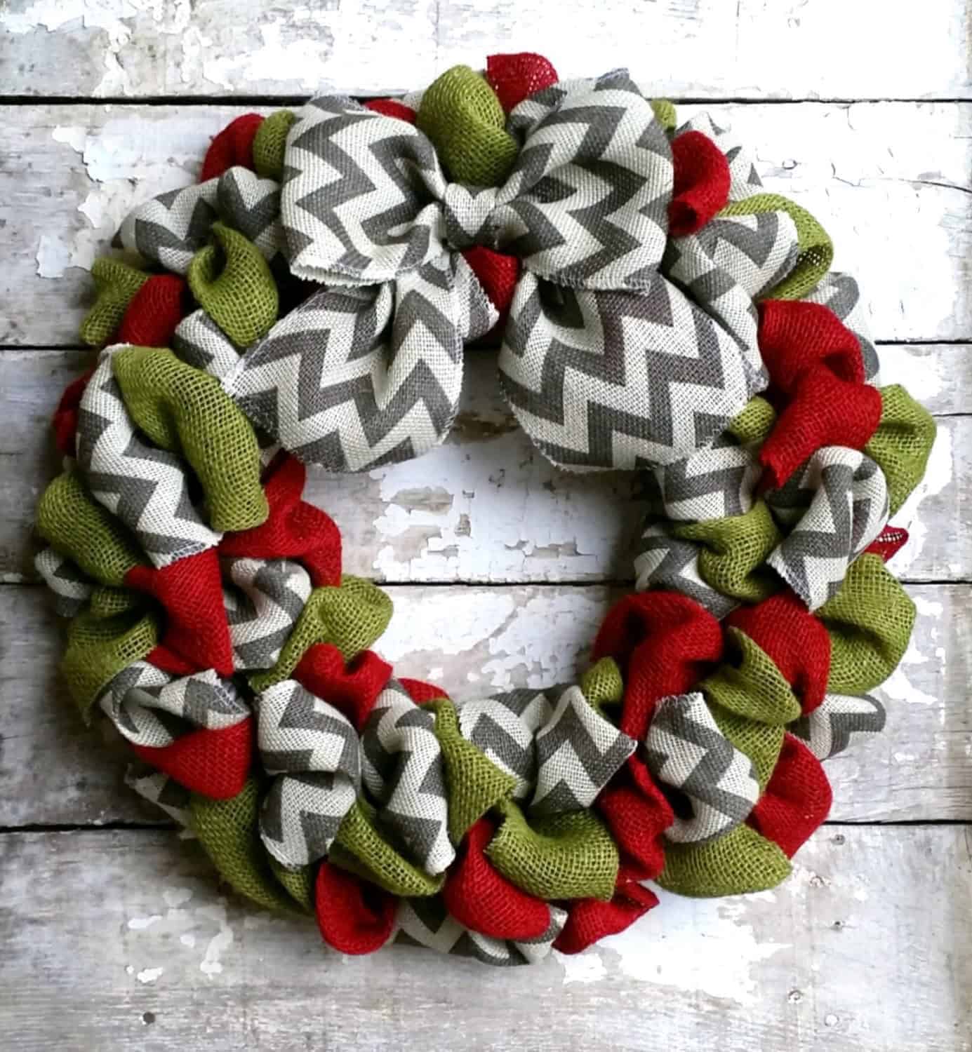 Chevron-pattern burlap Christmas wreath with red and green loops and bow