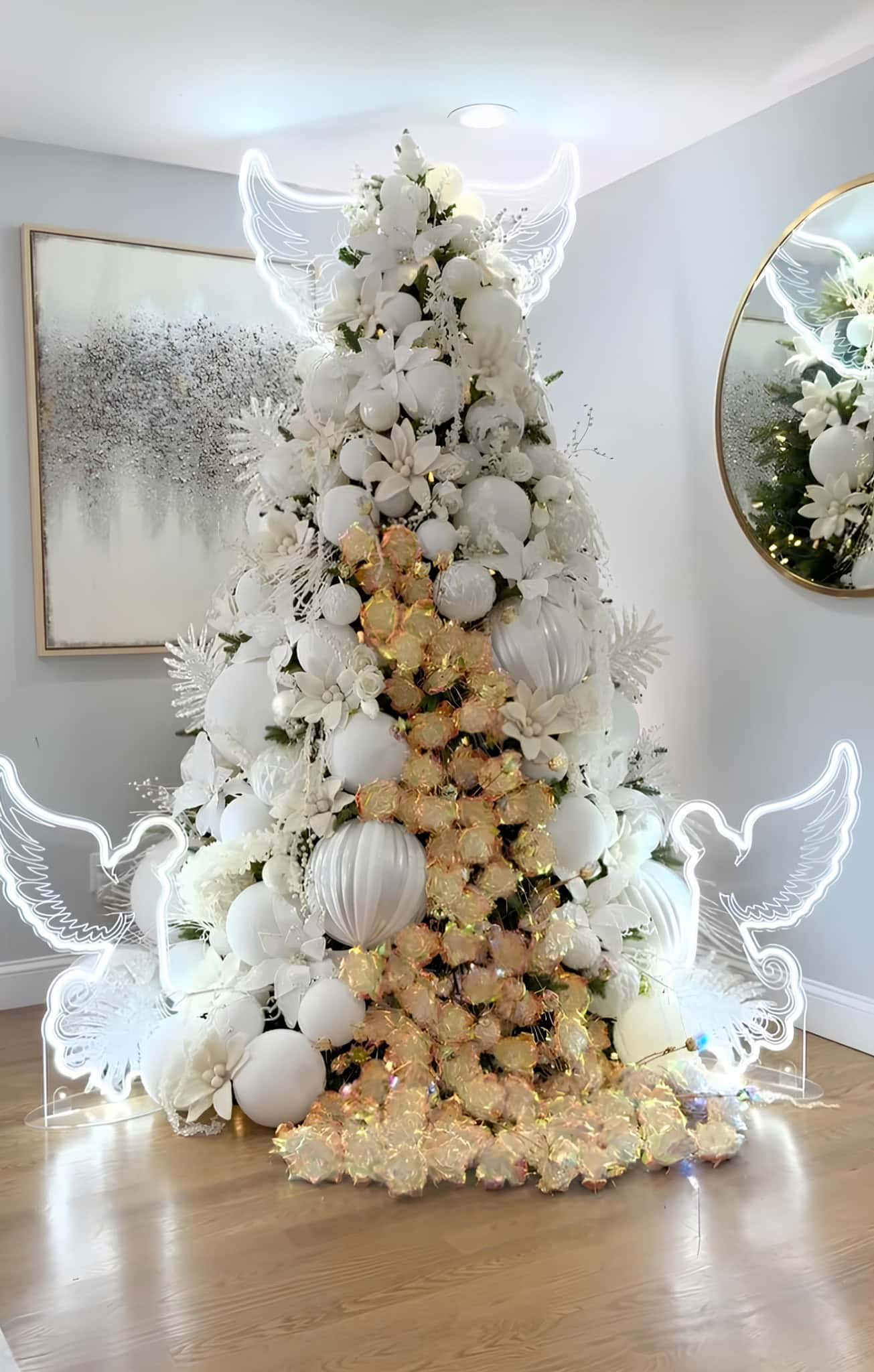 All-white Christmas tree with angel wing outlines, florals, and iridescent highlights