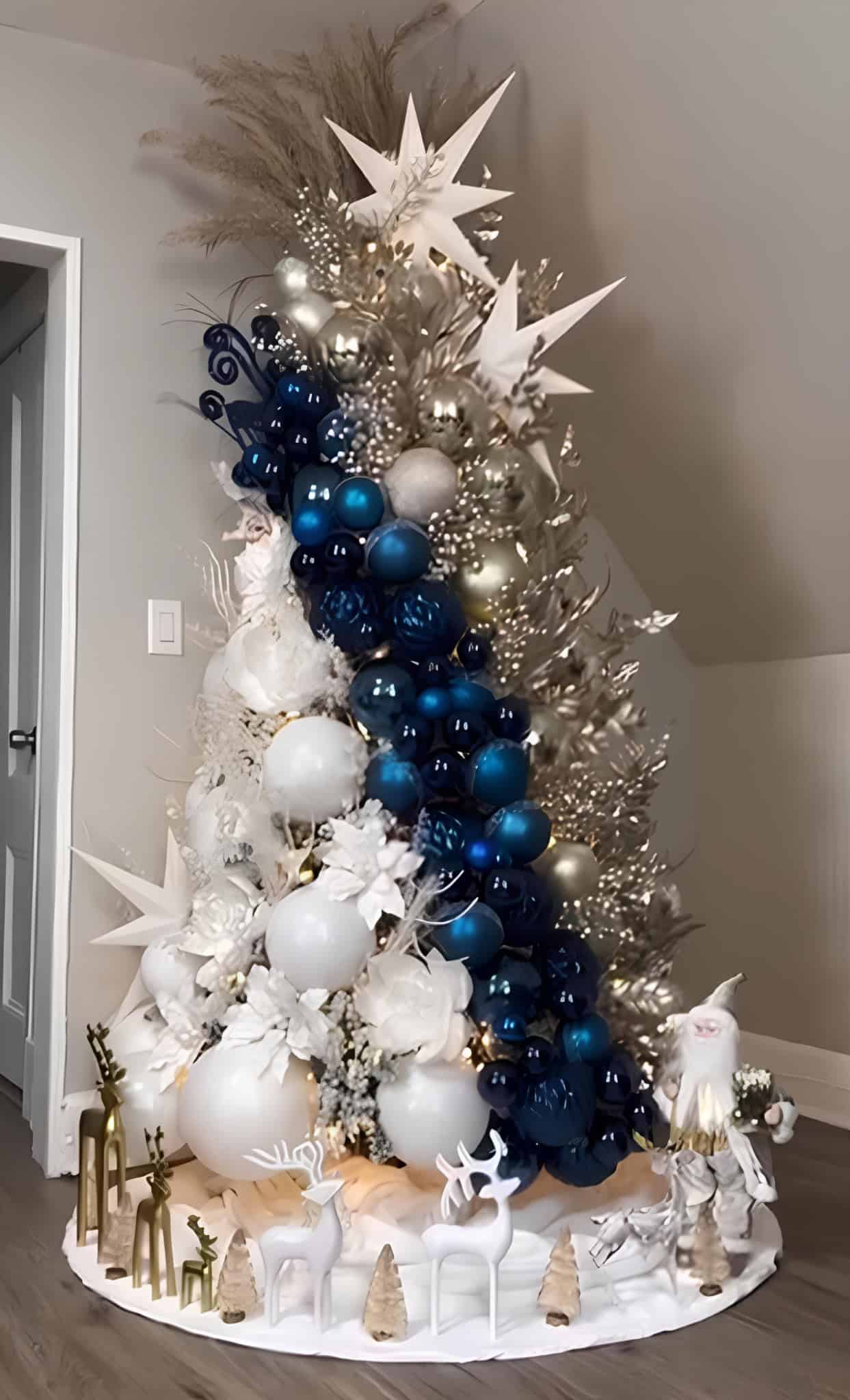 Blue and white Christmas tree with star toppers, pampas sprays, and metallic foliage