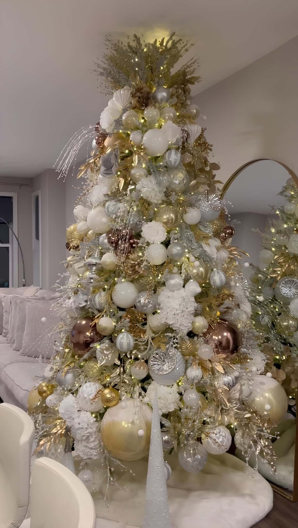 Champagne gold and white Christmas tree with pearl ornaments, shell motifs, and shimmering branches