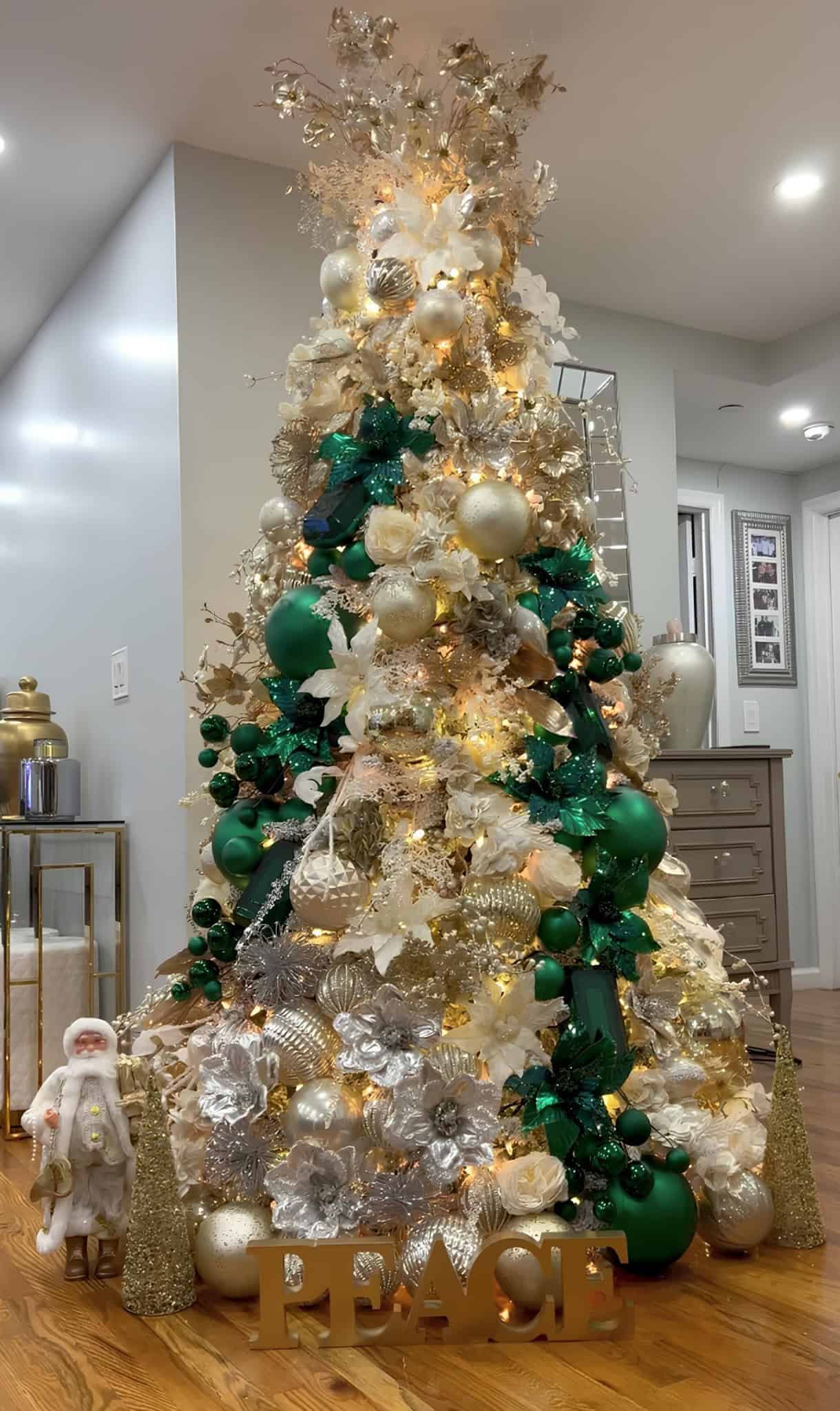 Emerald green and gold Christmas tree with metallic ornaments and peace sign decoration