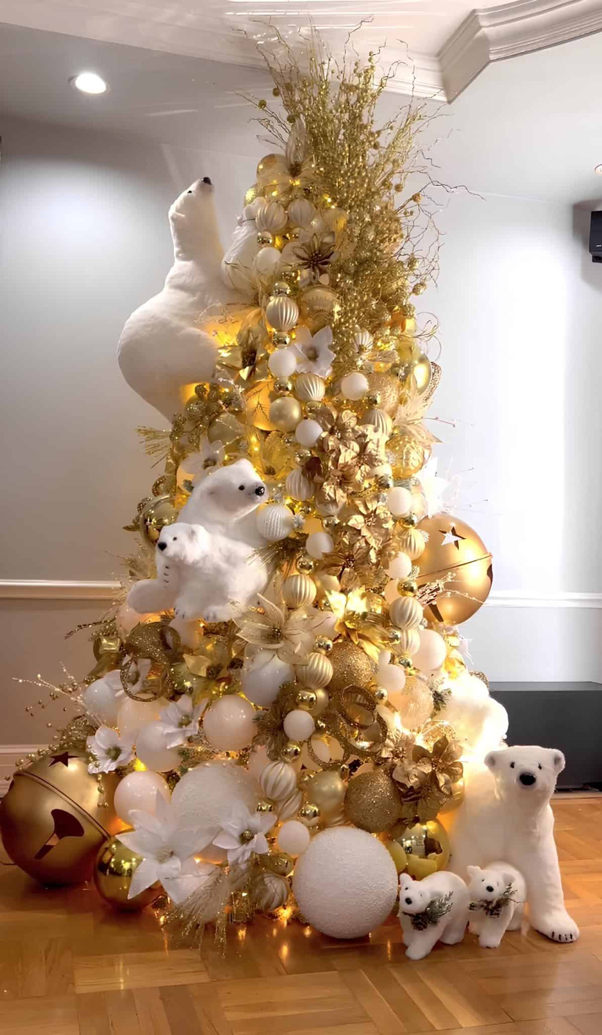 Luxurious gold and white Christmas tree with polar bear family and oversized baubles