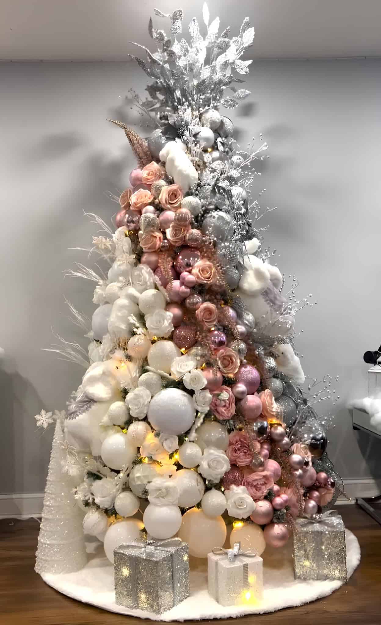 Pink and silver Christmas tree with roses, pearl picks, and glitter gift boxes