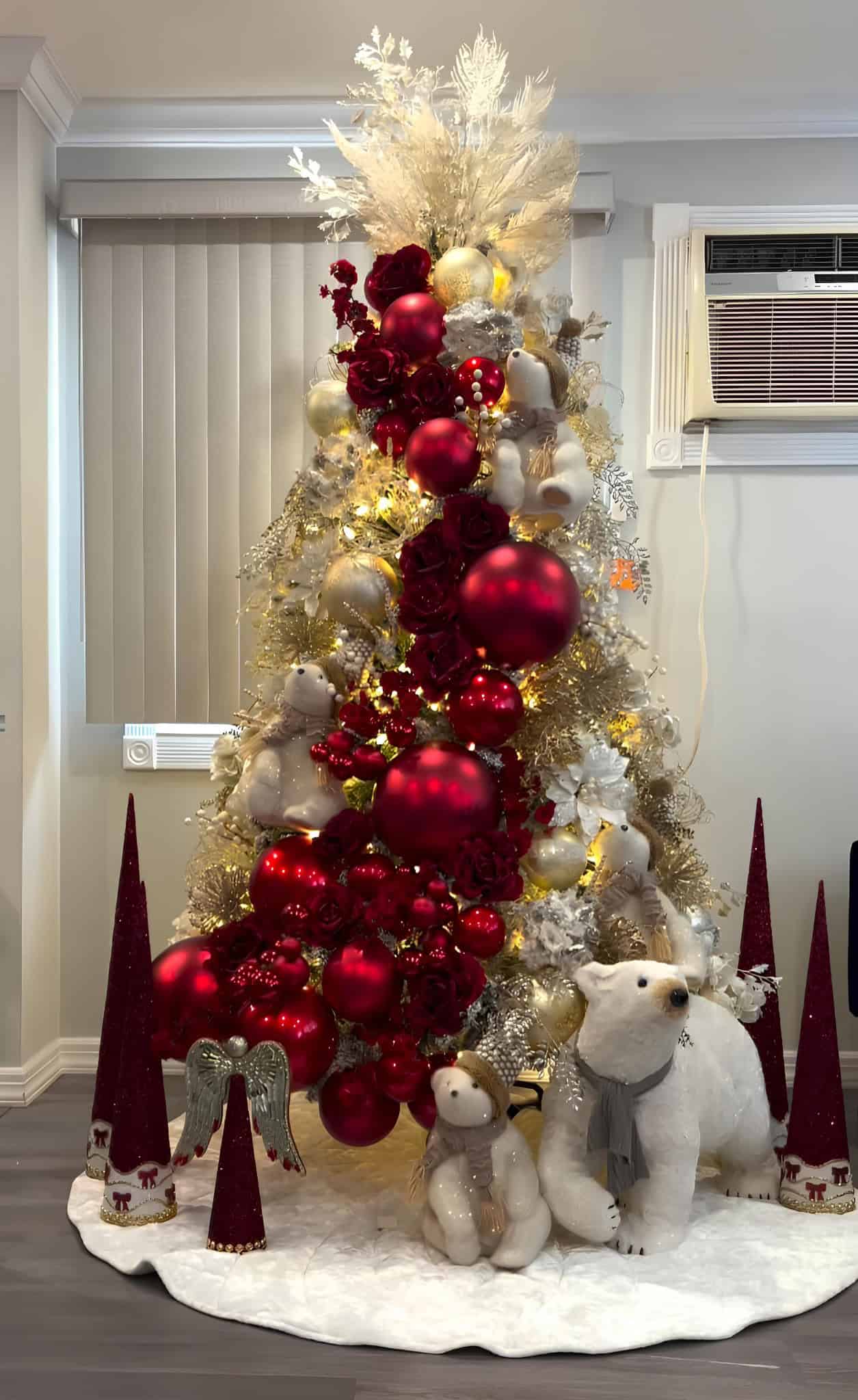 Elegant red and gold Christmas tree with polar bear figures and glitter ornaments