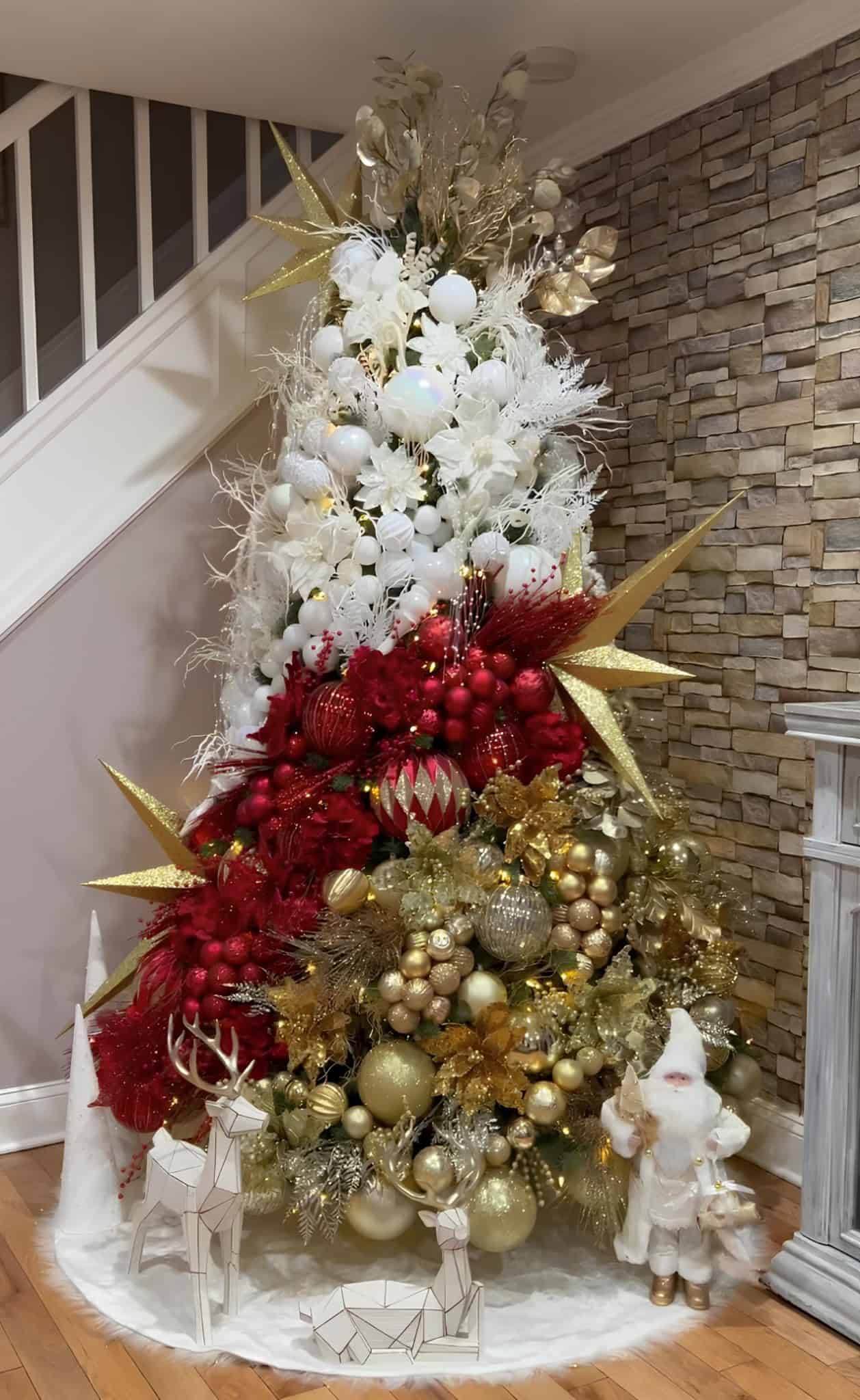 Luxurious white and red Christmas tree decorated with gold ornaments, festive ribbons, and holiday lights, designed for elegant holiday decor and seasonal interior decoration.