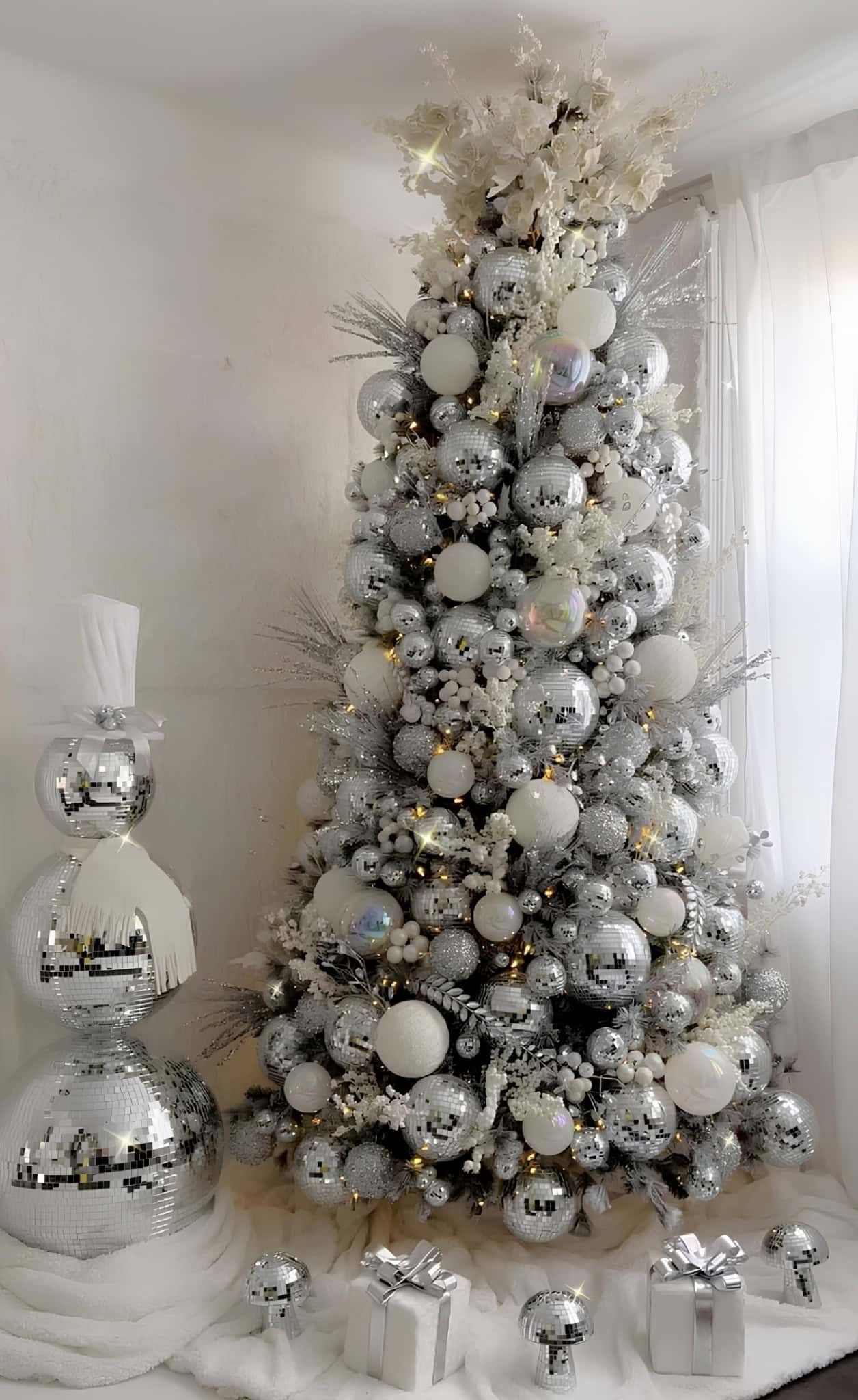 Silver Christmas tree with disco mirror balls, white accents, and shimmering mushrooms