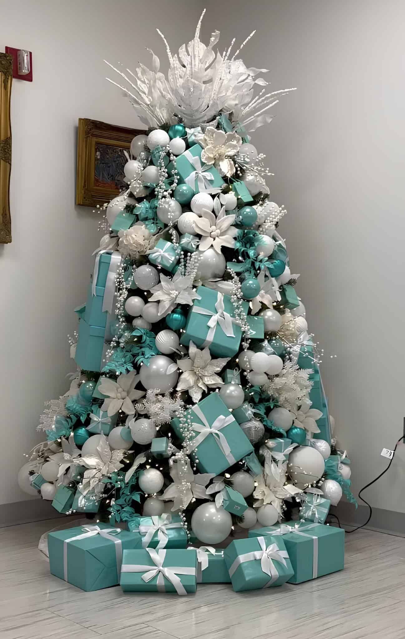 Tiffany blue and white Christmas tree with stacked gift boxes, white florals, and pearl accents