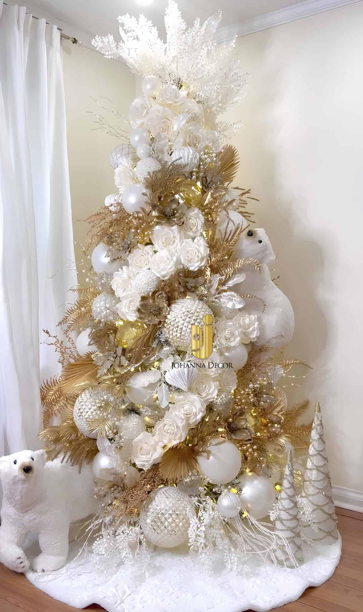 White and gold Christmas tree with large roses, luxe ornaments, and polar bear accents