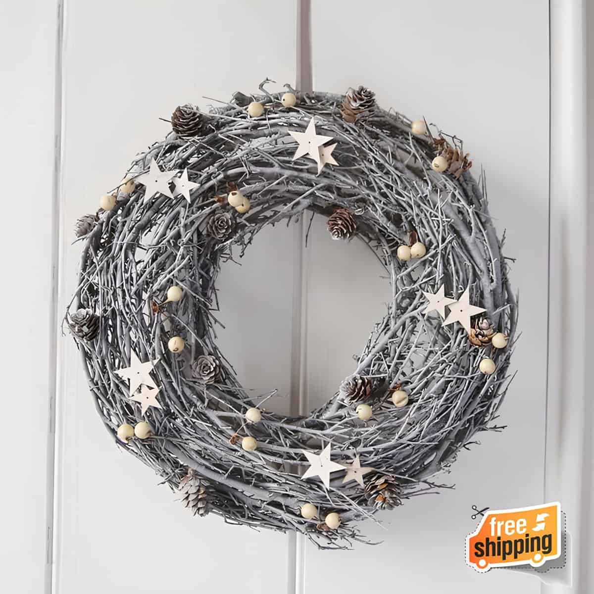 Gray painted twig wreath with wooden stars, mini pinecones, and beads