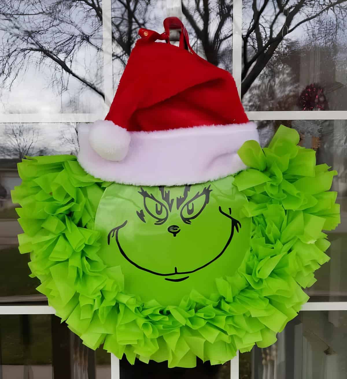 Green Grinch Christmas wreath with Santa hat and fabric ruffles