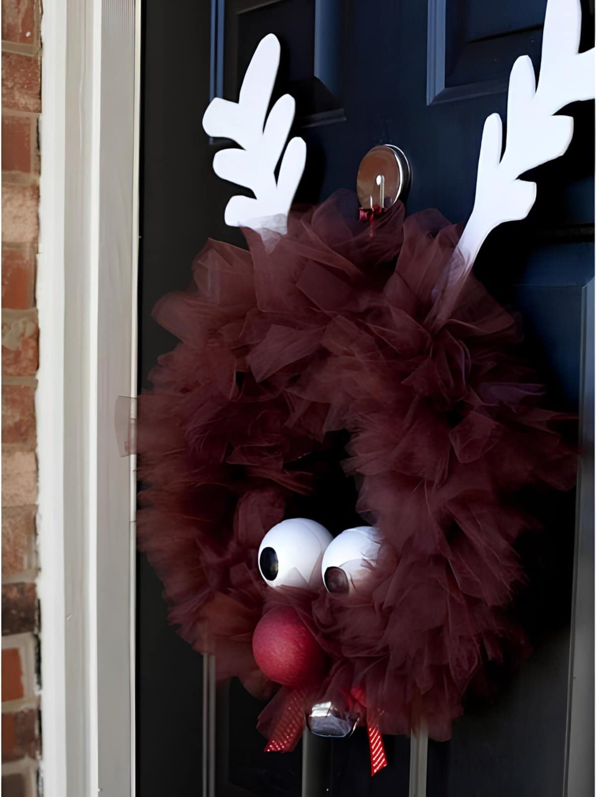 DIY Christmas wreath made of brown tulle with reindeer antlers and red nose