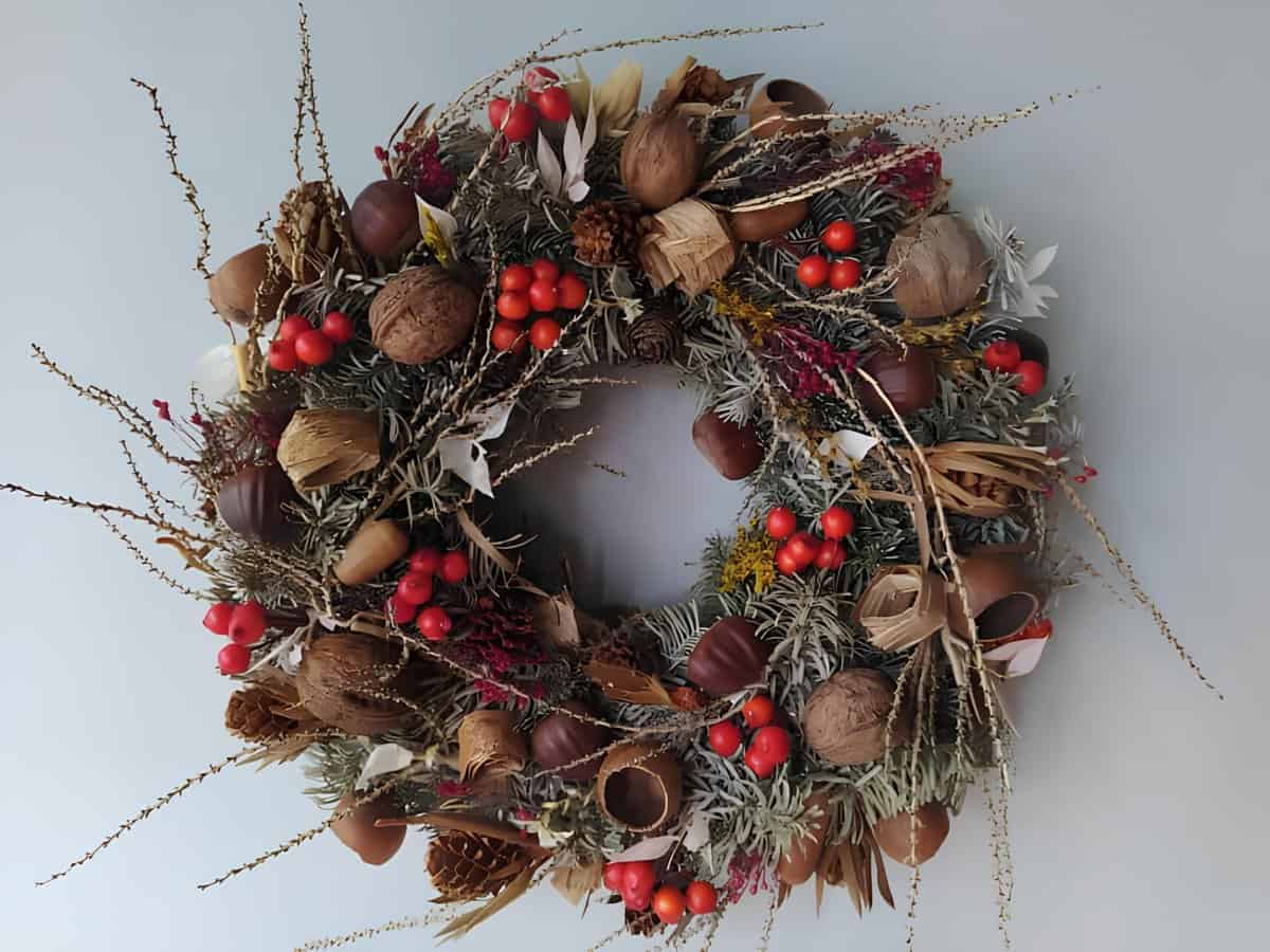 Rustic Christmas wreath with natural accents like nuts, pinecones, and berries