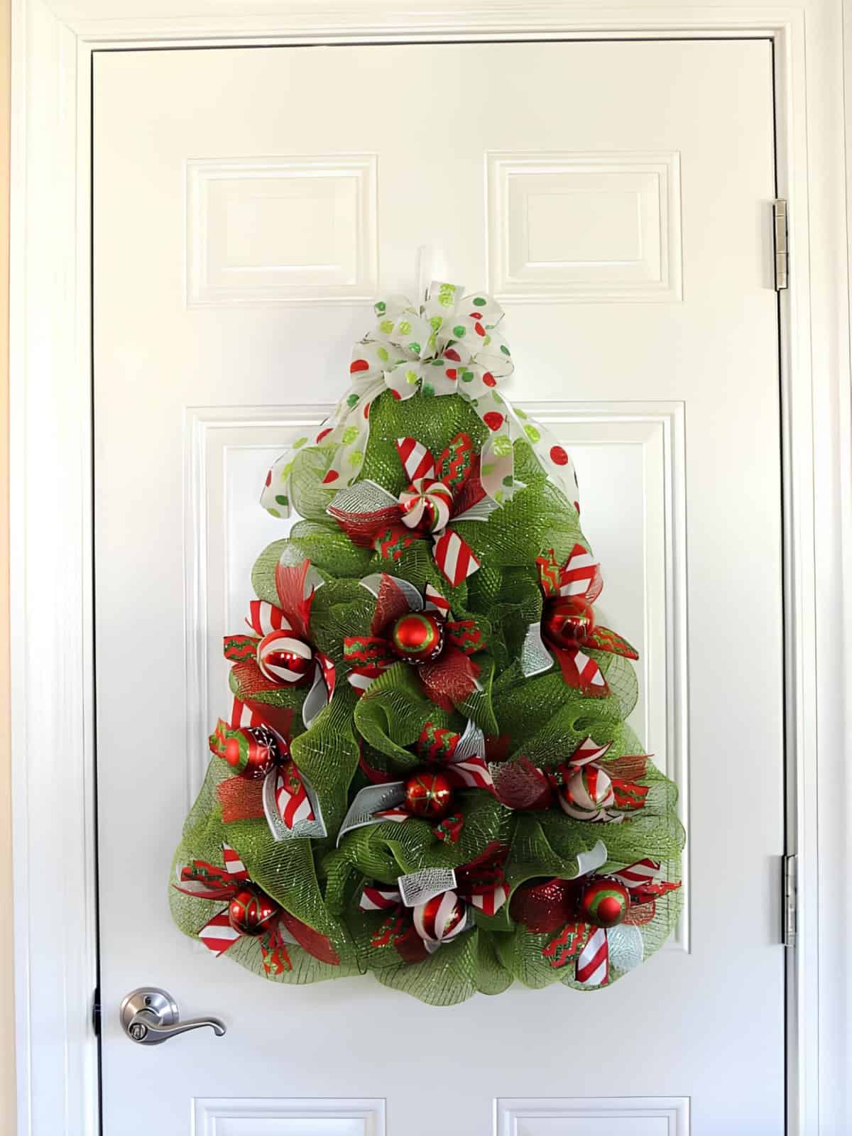 Christmas wreath shaped like a tree with green mesh and red ribbons