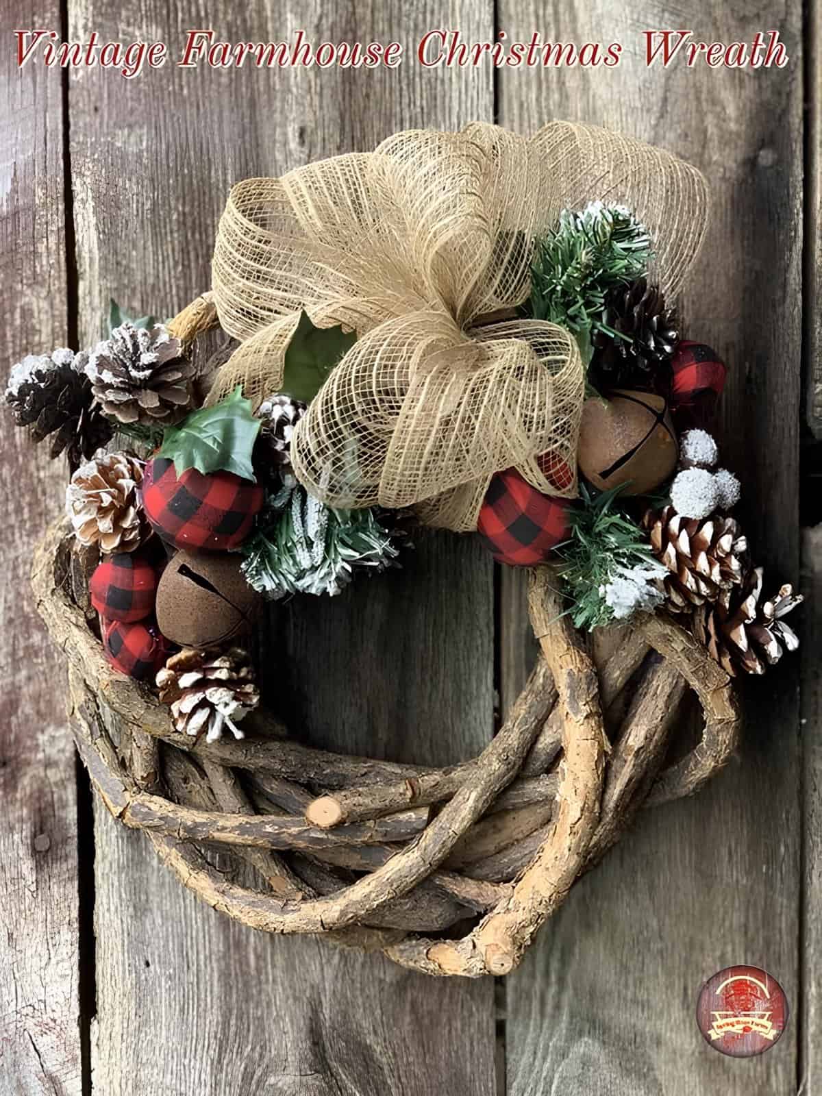 Rustic vine wreath with burlap bow, buffalo plaid bells, frosted pinecones, and greenery