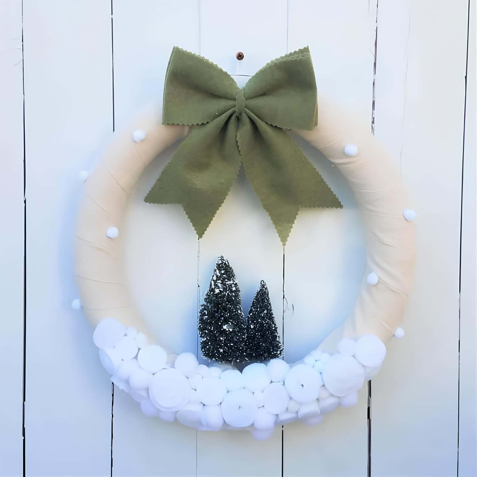 Elegant Christmas wreath with cream berries on a dark door